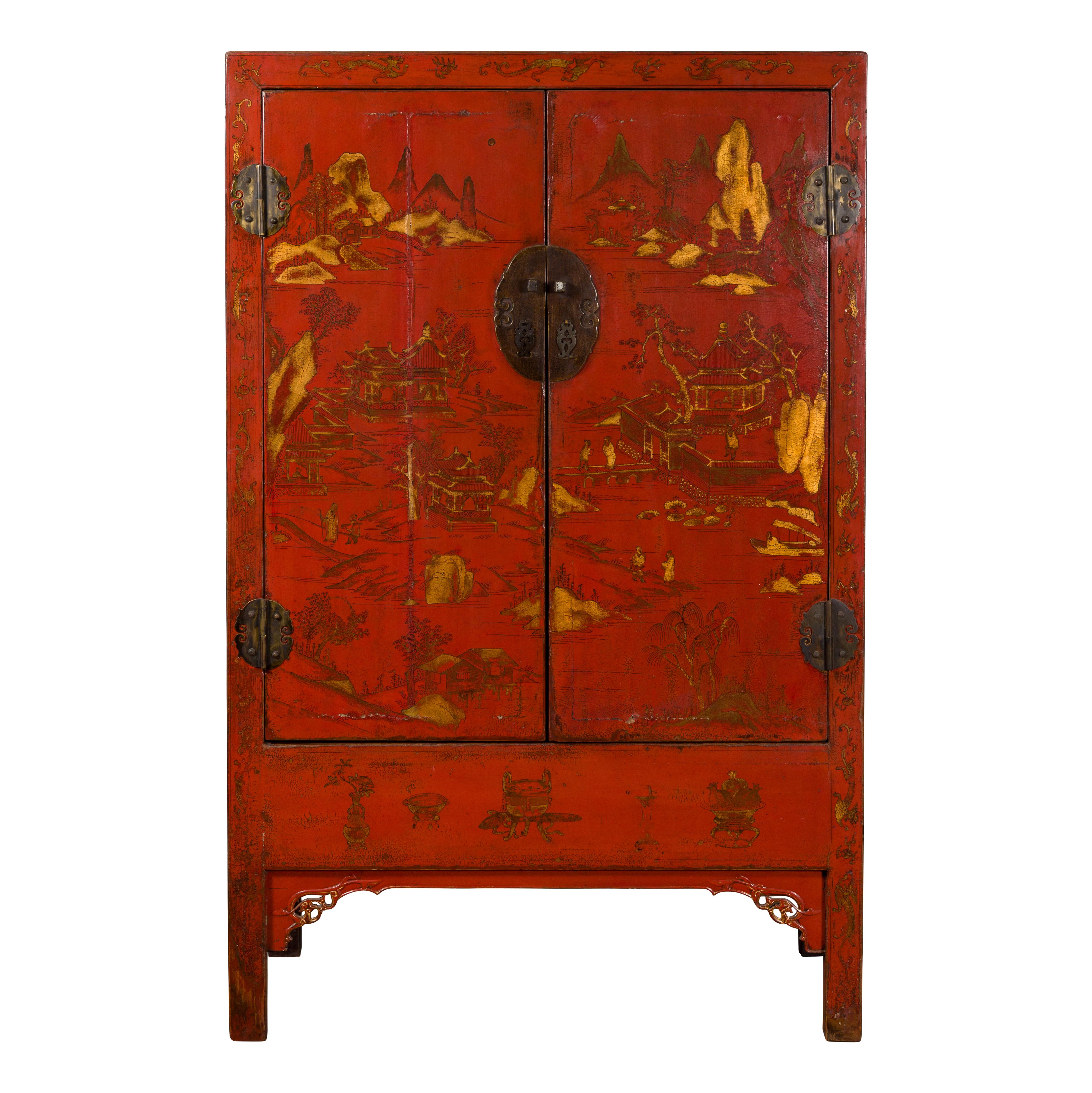 A Chinese Qing Dynasty period original red lacquer cabinet from the 19th century, with gilt Chinoiserie décor. Created in China during the Qing Dynasty, this cabinet features a linear silhouette perfectly accented by a red lacquered ground
