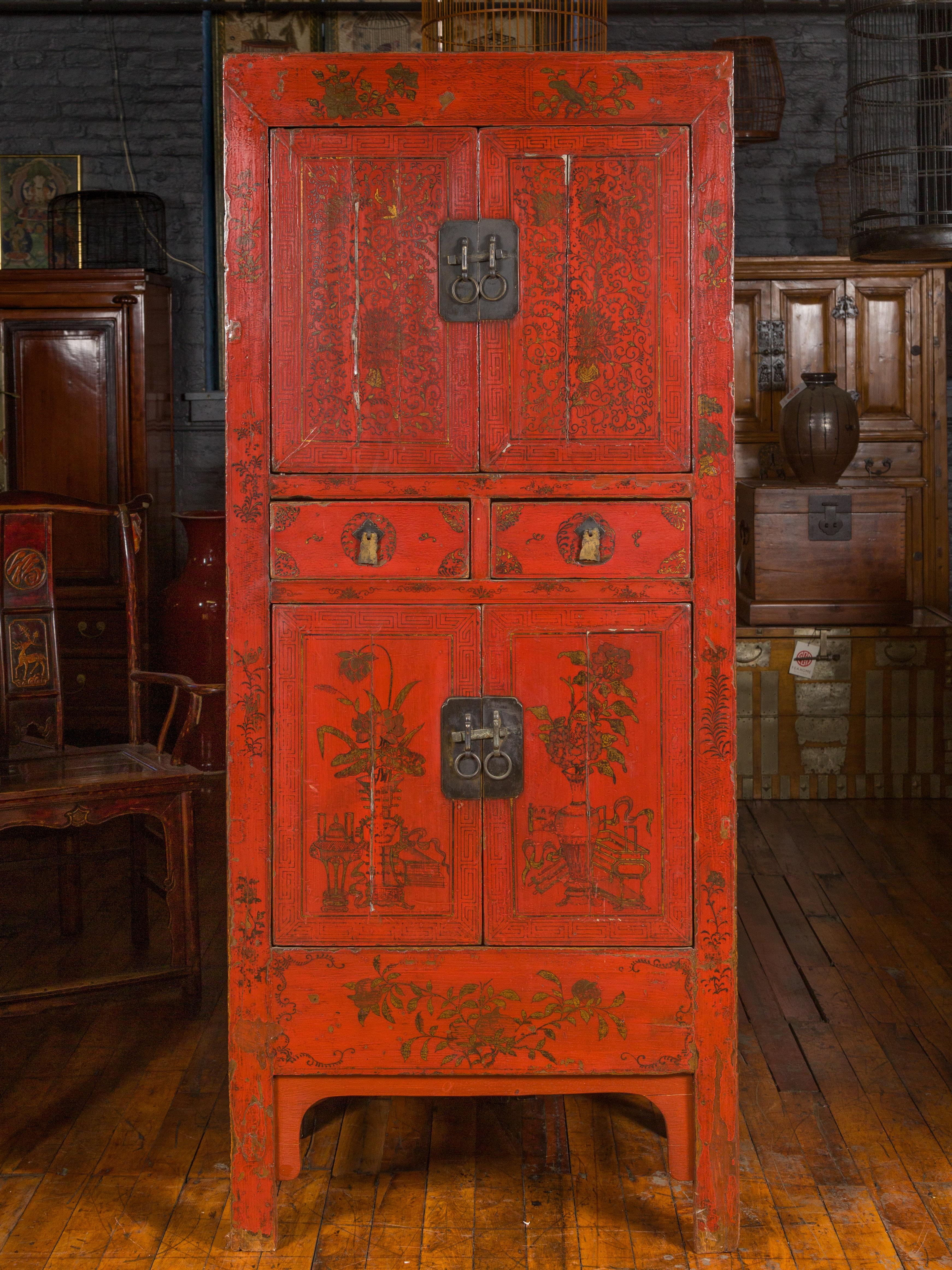 A Chinese Qing dynasty red lacquered cabinet from the 19th century, with distressed gold floral decor, doors and drawers. Crafted in China during the Qing dynasty, this tall cabinet features a red lacquered ground delicately accented with distressed
