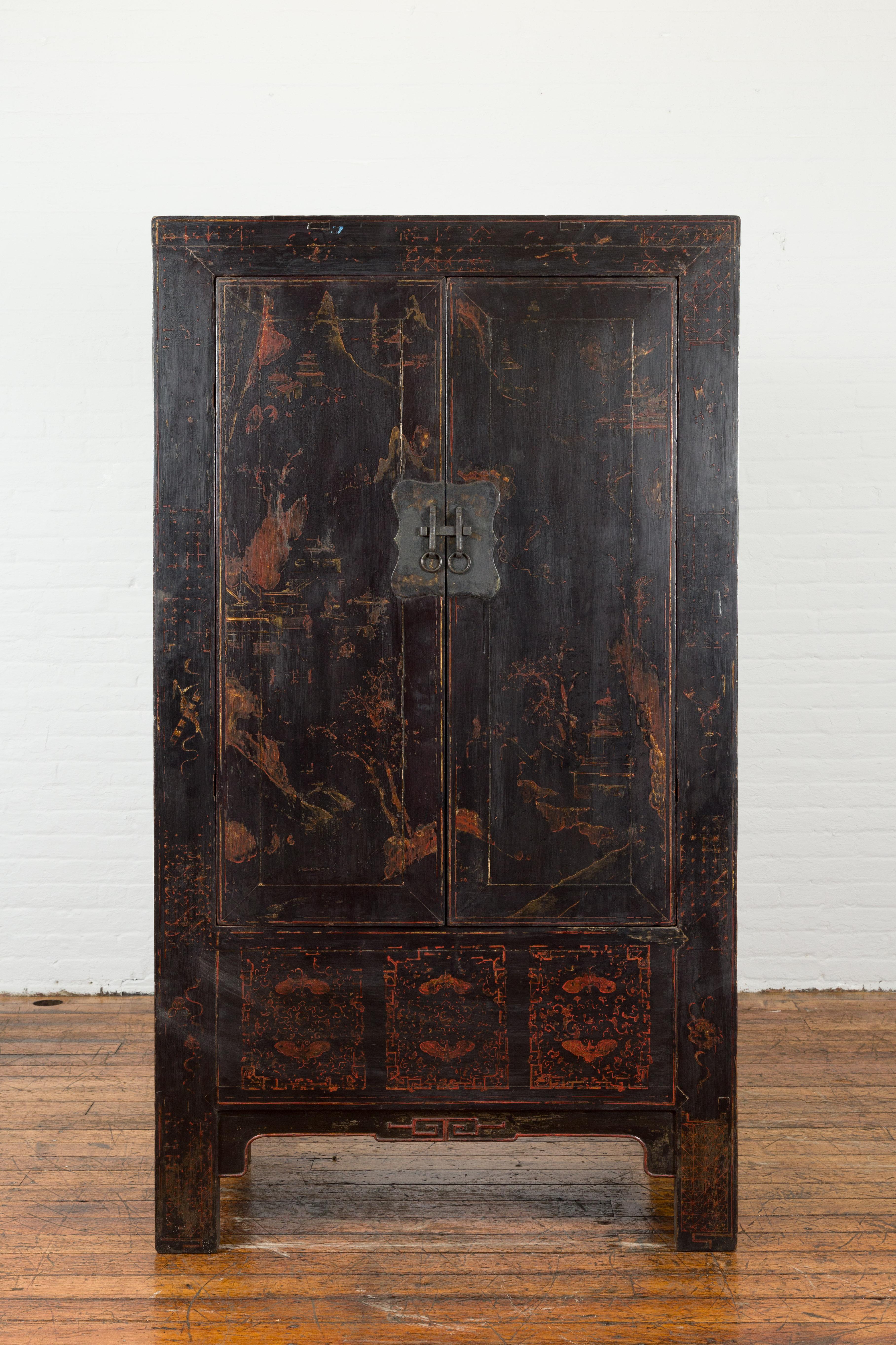 A Chinese Qing Dynasty period Shanxi cabinet from the 19th century, with original lacquer. Created in the North-Eastern province of Shanxi during the Qing dynasty, this 19th century cabinet features its original black lacquer structure, adorned with