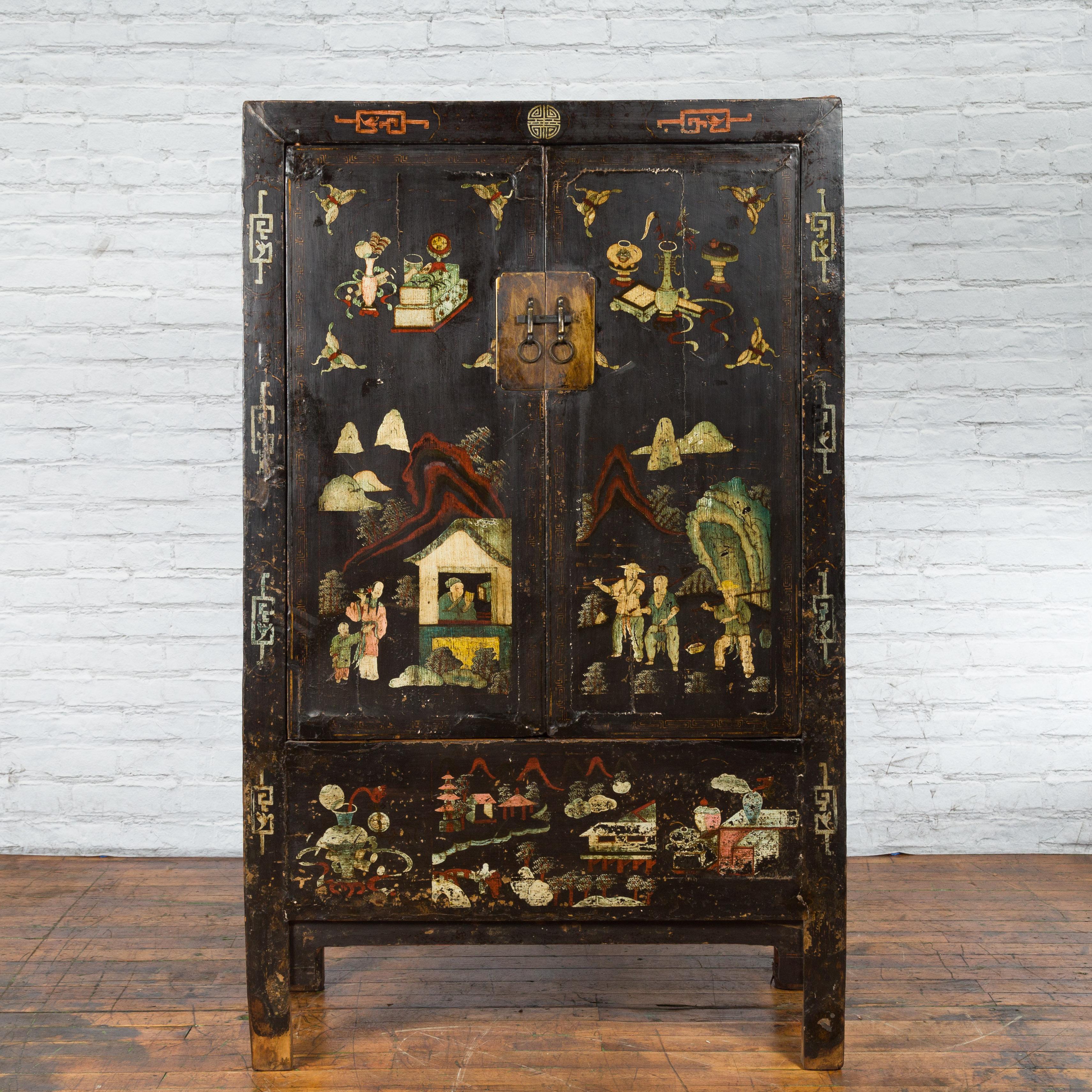 A Chinese Qing Dynasty period Shanxi cabinet from the 19th century, with original lacquer and hand-painted décor. Created in the North-Eastern province of Shanxi during the Qing dynasty, this 19th century cabinet features its original black lacquer