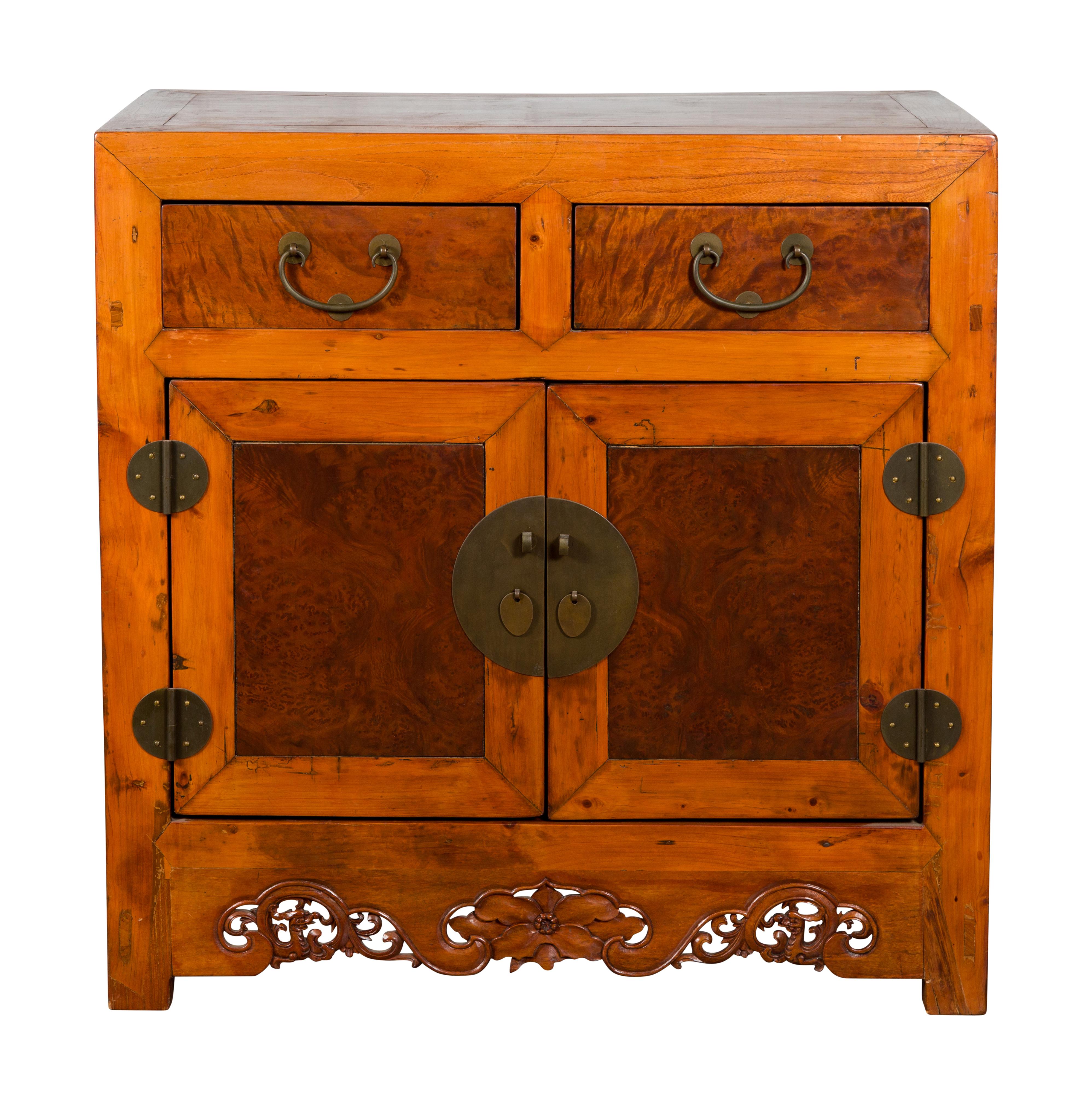 A Chinese Qing Dynasty period two-toned elm wood cabinet from the late 19th century, with dragon and floral carved apron, natural color, burl wood doors and drawers. Created in China during the Qing Dynasty period in the later years of the 19th