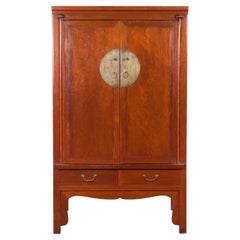 Used Chinese Qing Dynasty Armoire with Brass Medallion and Reconfigured Pocket Doors