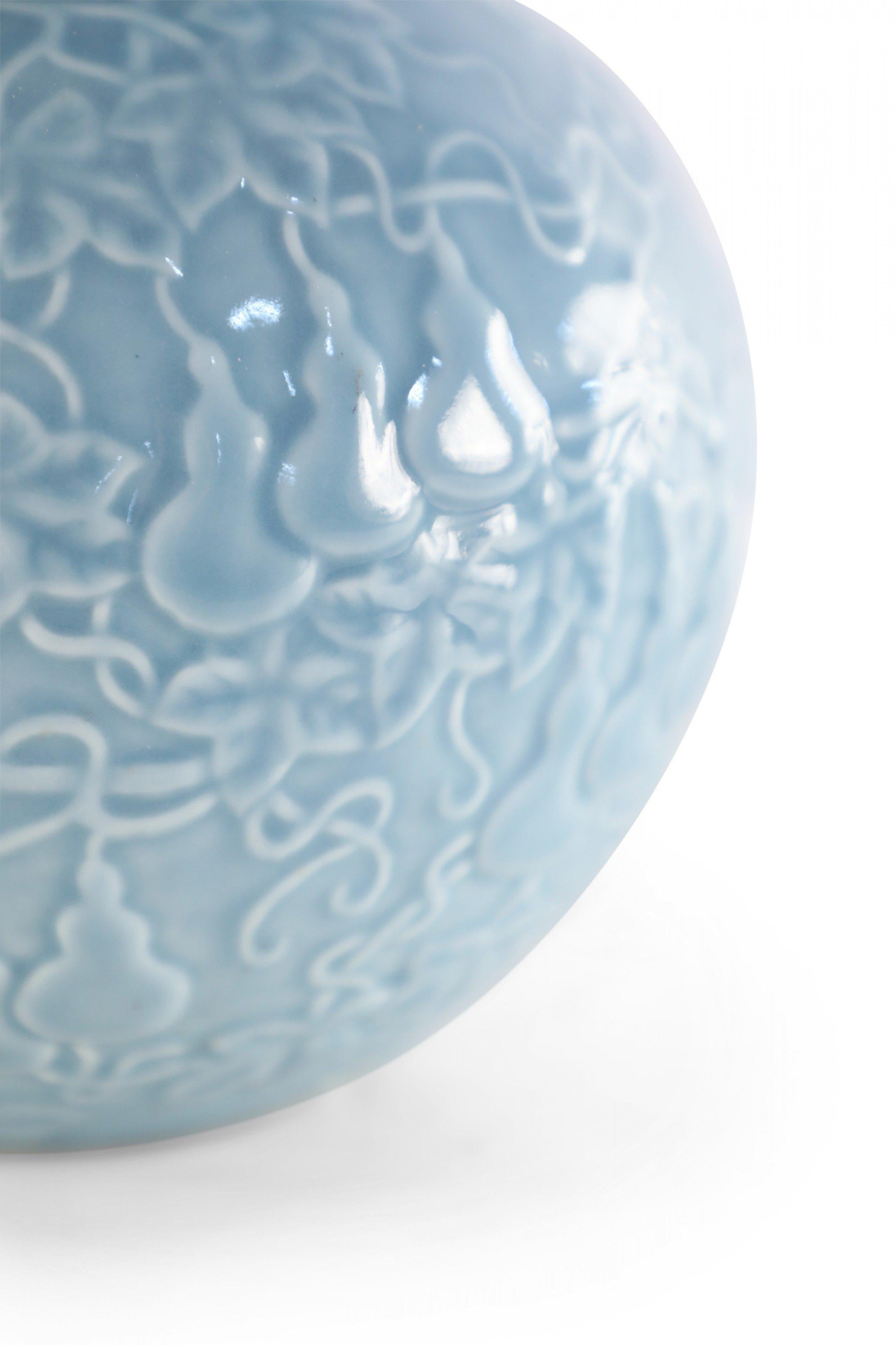 Chinese Qing Dynasty Style (20th Century) blue porcelain double-gourd vase with a raised vine and pear pattern that symbolizes a traditional blessing for longevity and abundance, and a gold rim (date mark on bottom).
 