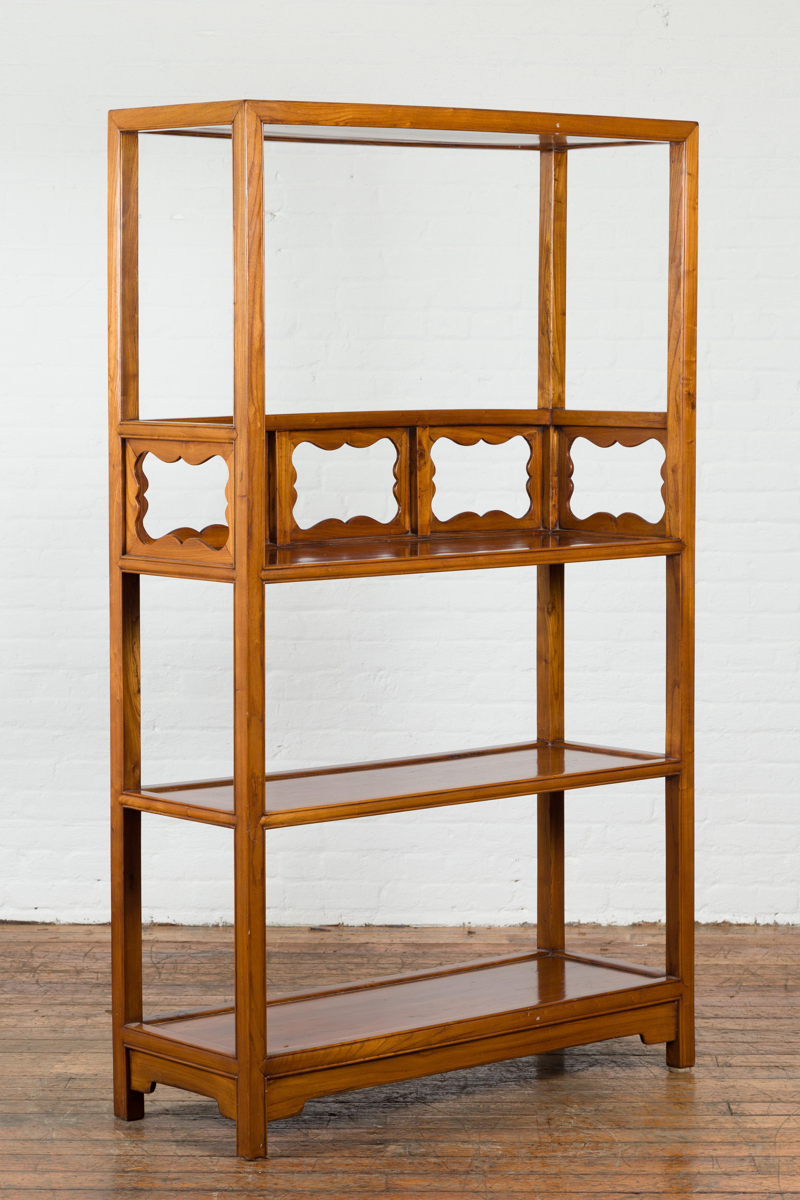A 19th century Qing Dynasty antique cabinet that beautifully displays clean, long lines  and artistic carvings. This antique bookshelf features three rectangular shelves offering plenty of room for books or decorative antique accent pieces. The top