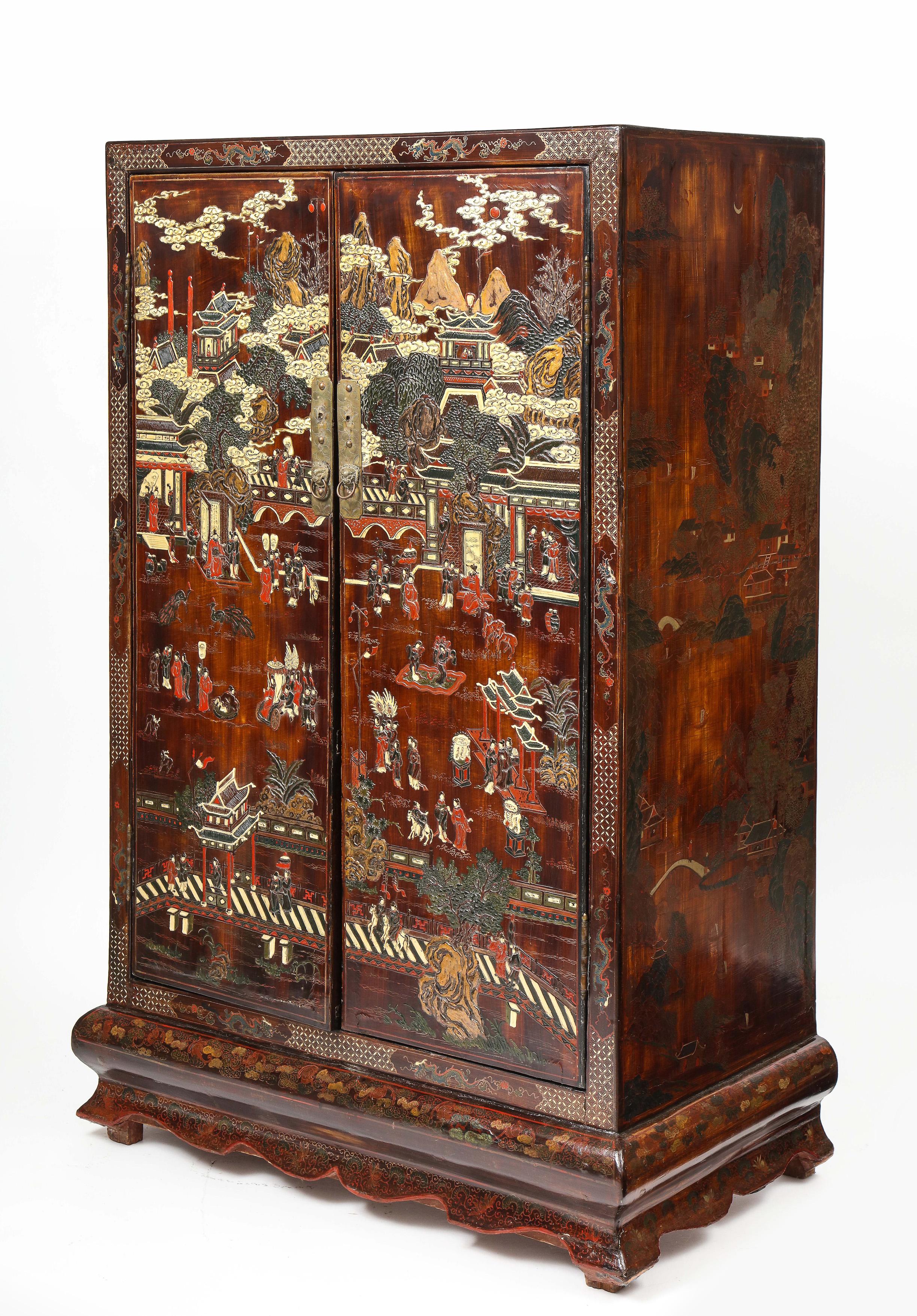 Exceptional example of a Chinese wedding cabinet with interior and exterior fully decorated. Fitted with two long doors depicting elaborate Court scene and opening to a vibrant red interior fitted with two drawers. Back decorated with a crane in a