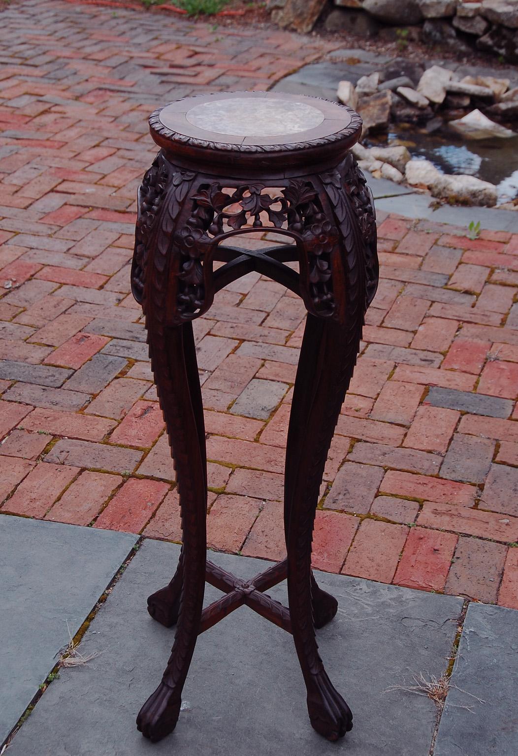 Chinese Qing dynasty carved rosewood pedestal with inset rose marble top. The elegant tall cabriole legs are connected by two cross stretchers, one near the top and one near the feet; having two cross stretchers increases the stability and strength
