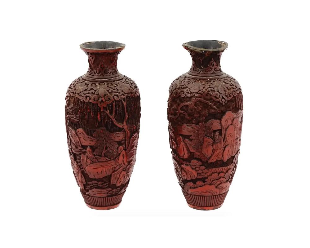 A pair of antique Chinese hand carved red cinnabar vases. Late Qing dynasty, before 1912. The body of the pieces is decorated with depictions of the elders among the mountain landscape. Collectible oriental decor for Interior Design.

Dimensions: