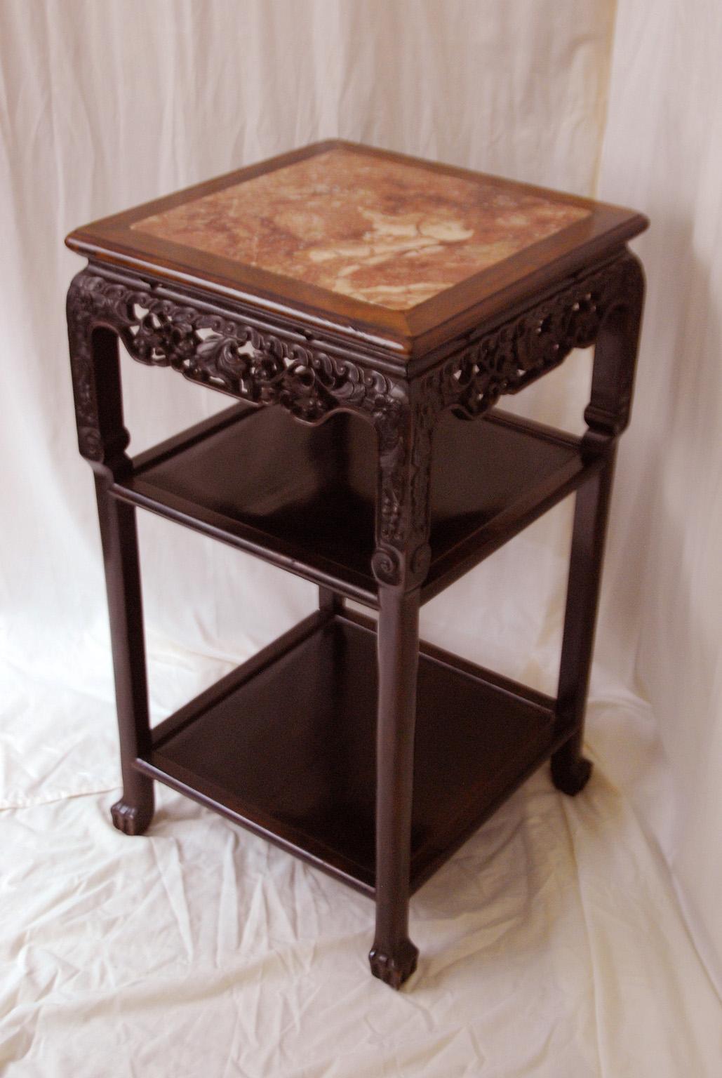 Chinese Qing dynasty carved rosewood display stand with two paneled shelves and rose marble square inlay to the top. The carving is subtle and elegant. This 31 3/4