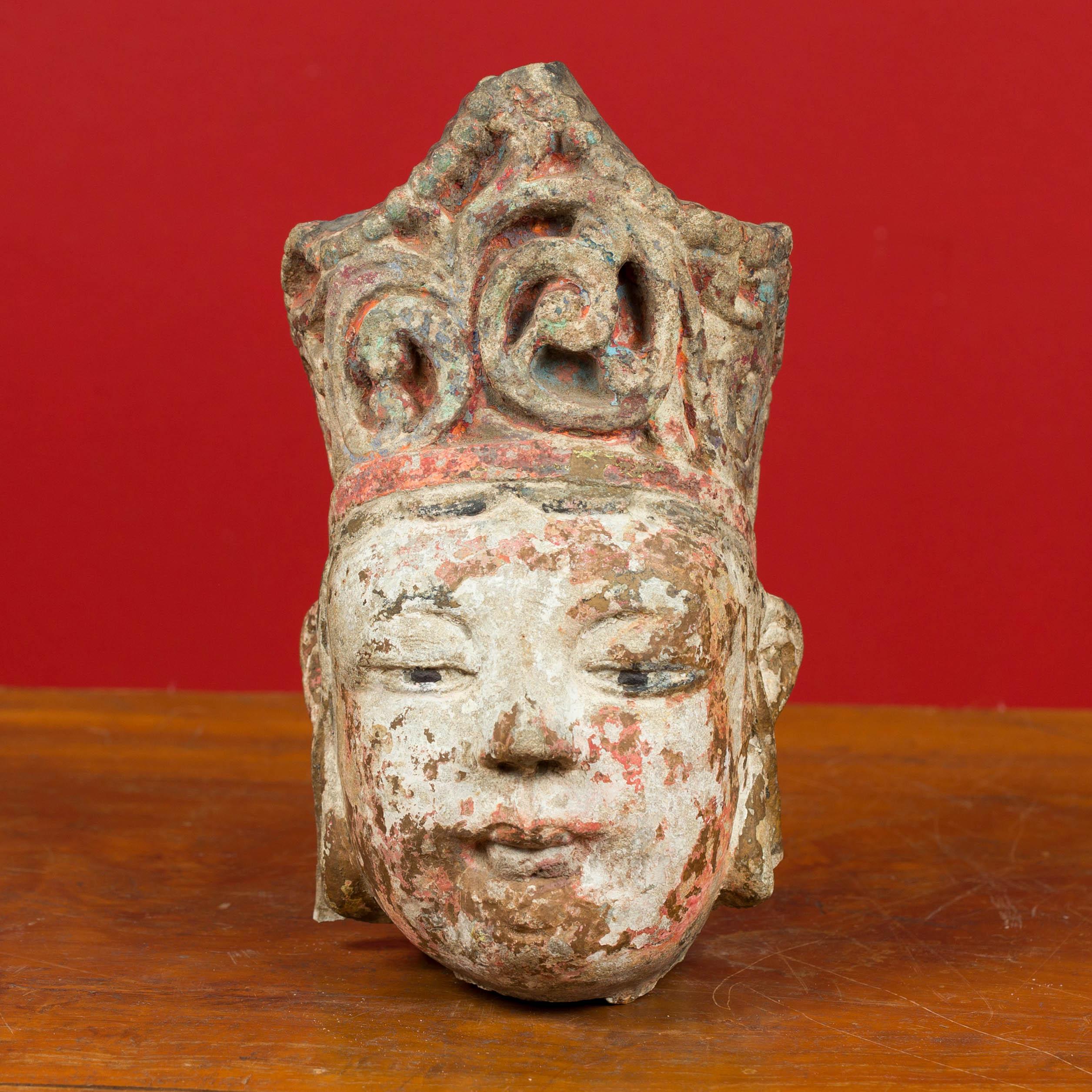 An antique Chinese carved stone court figure head sculpture with original polychromy. Attracting our attention with its tall headdress and remnants of original polychromy, this Chinese sculpture depicts a court figure. Unfinished in the back, the