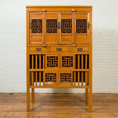Chinese Qing Dynasty Elm Cabinet with Fretwork Motifs, Doors and Sliding Panels