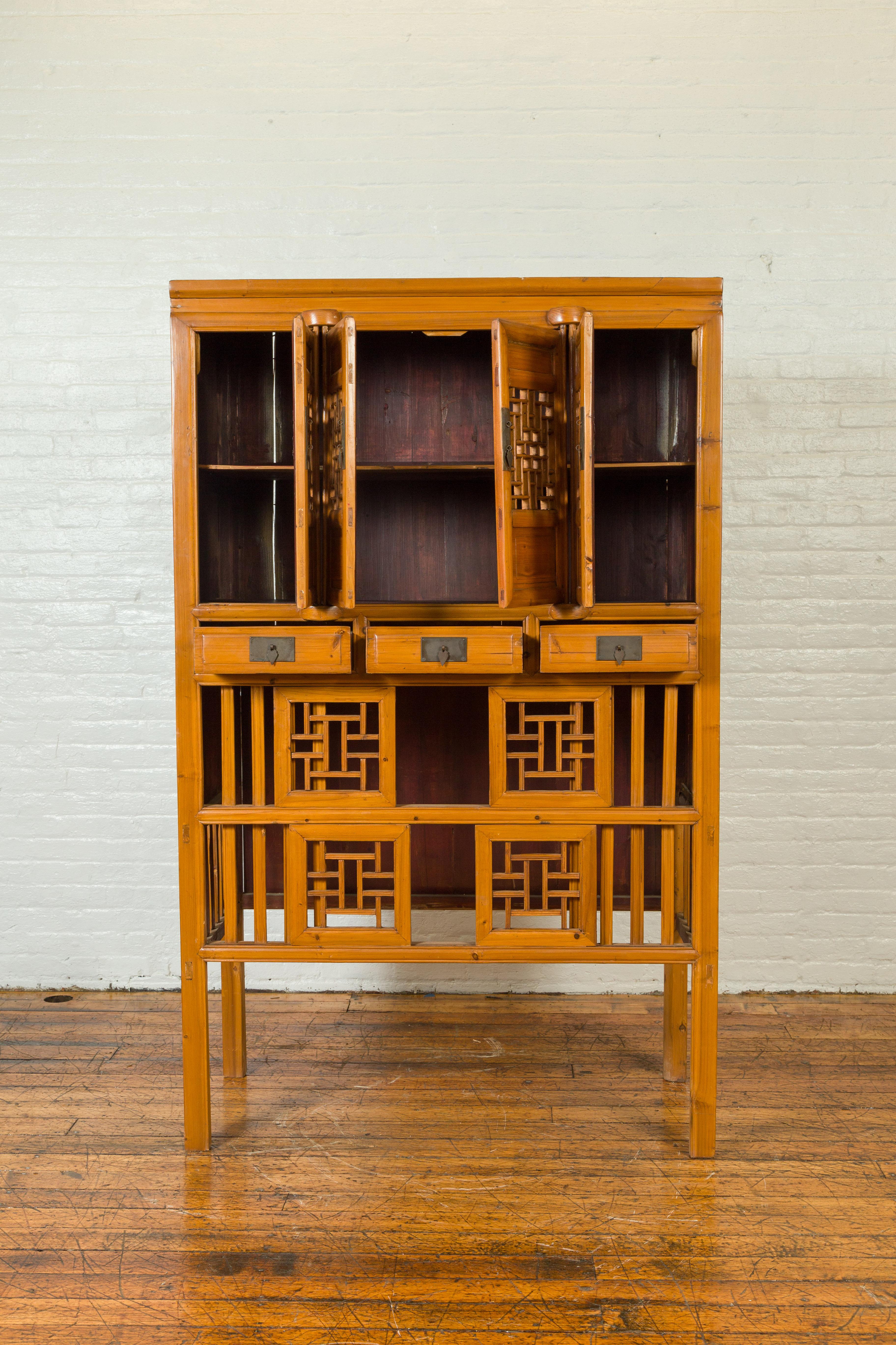 20th Century Chinese Qing Dynasty Elm Cabinet with Fretwork Motifs, Doors and Sliding Panels