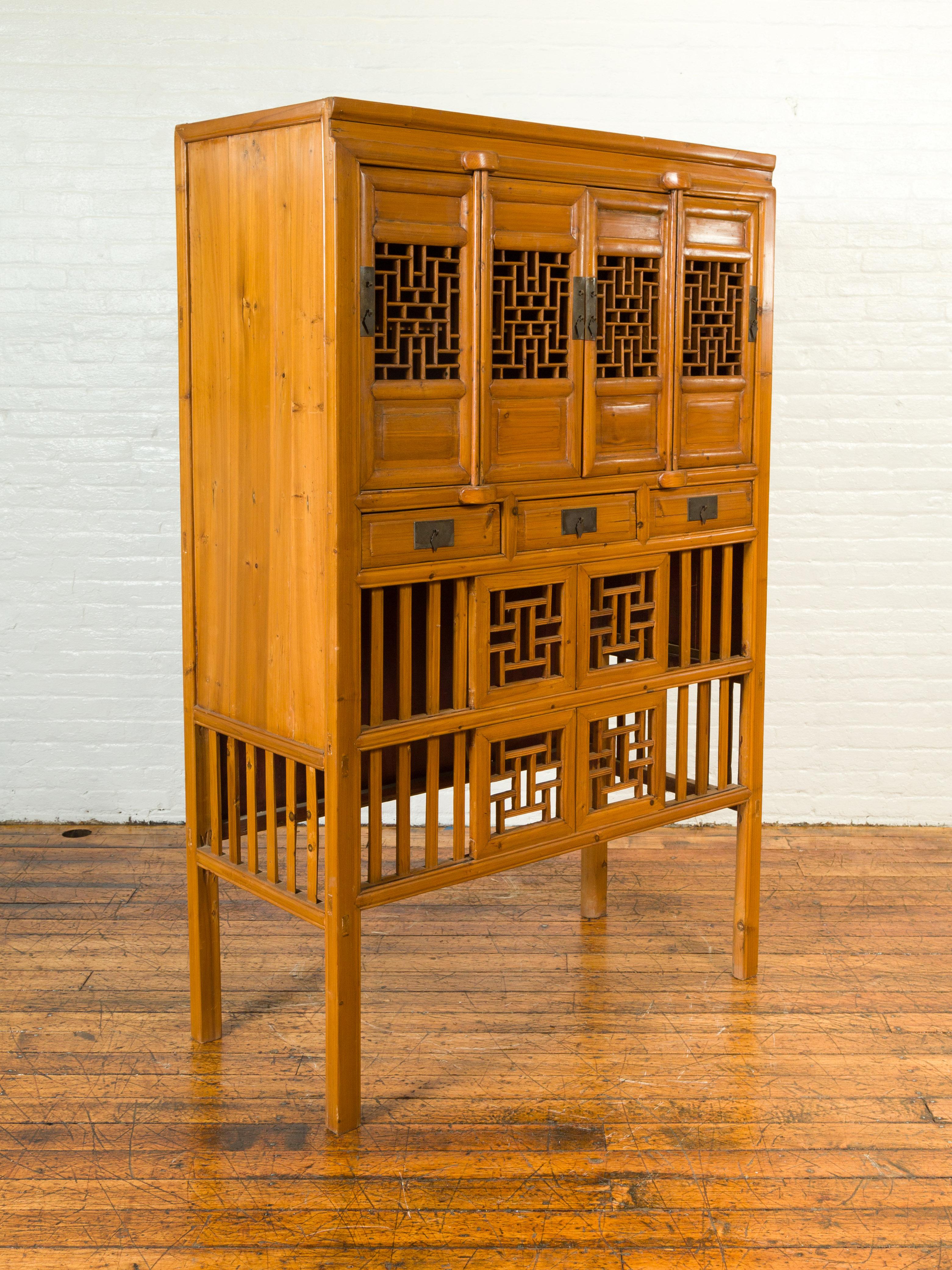 Chinese Qing Dynasty Elm Cabinet with Fretwork Motifs, Doors and Sliding Panels 1
