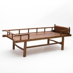 Chinese Qing Dynasty Elm Daybed with Carved Fo Dog Motifs and Bamboo Base