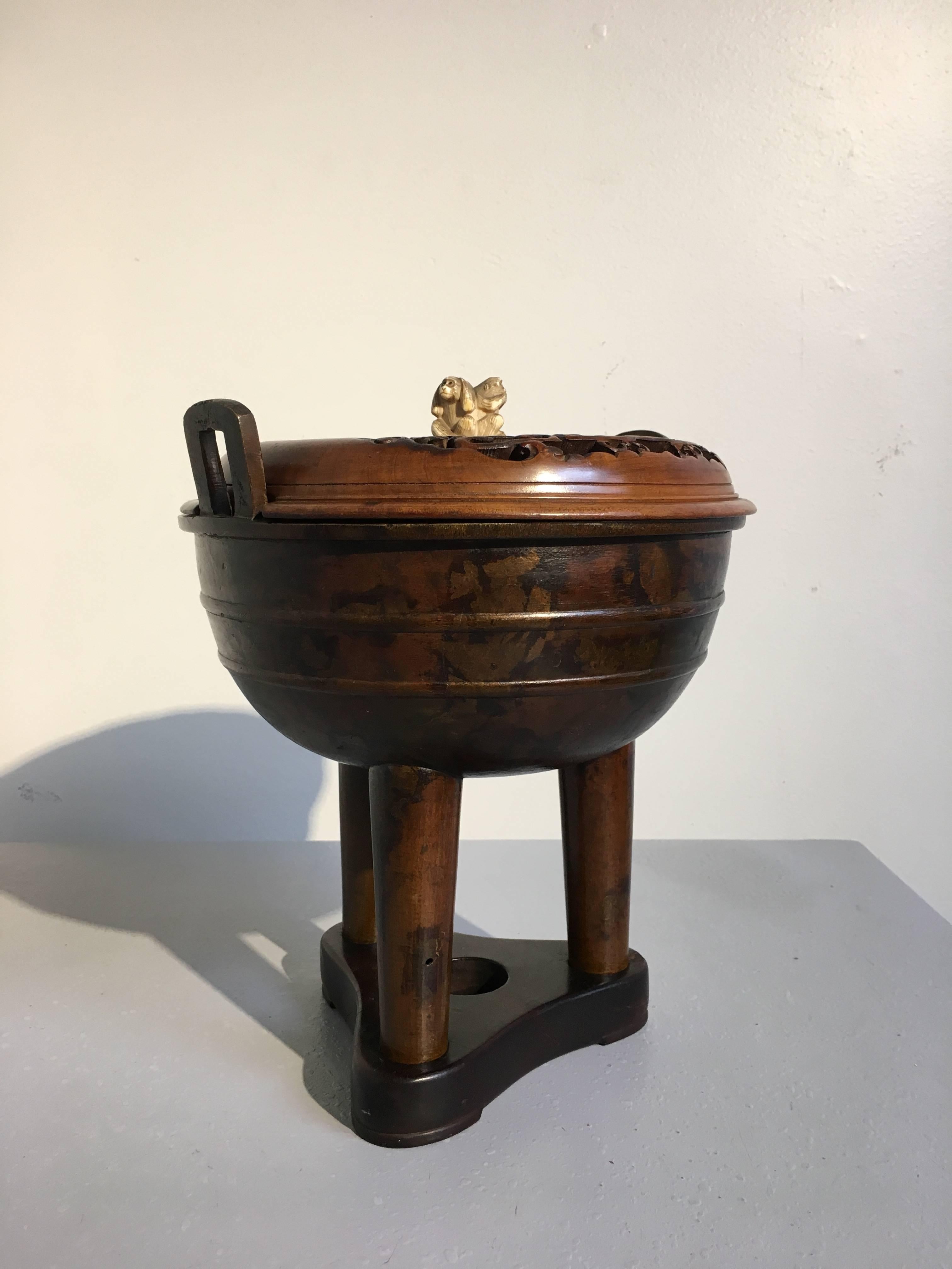 A stunning and unusual late 17th century early Qing dynasty Chinese gold splashed and lacquer patinated bronze censer in the form of an archaistic ding. The bulbous vessel sits on cylindrical tripod legs, a pair of bail handles rising from the rim.