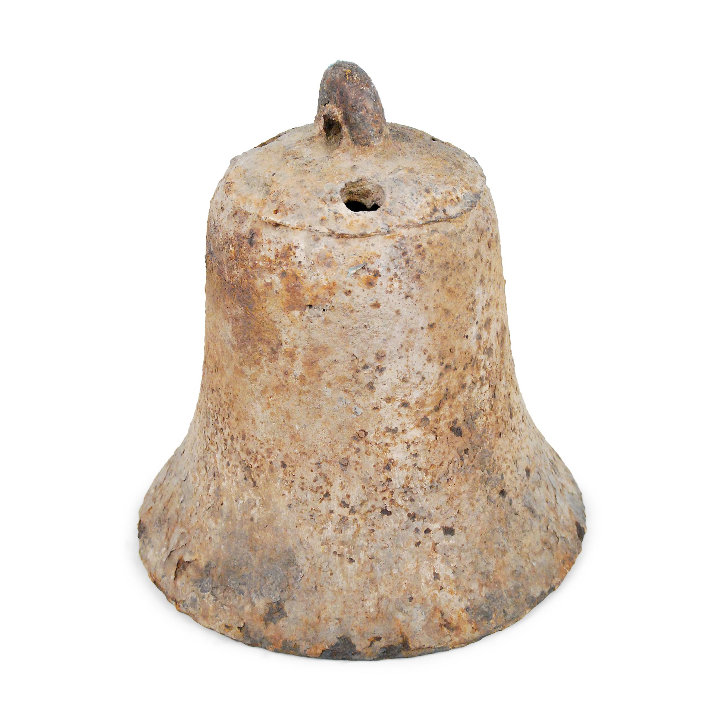 This rustic, 19th century iron bell once pealed in celebration or gave notice of important events in a town in northern China. Marked with holes to affix the clapper or insert a pole, the bell has a well-worn, rusted surface texture that looks