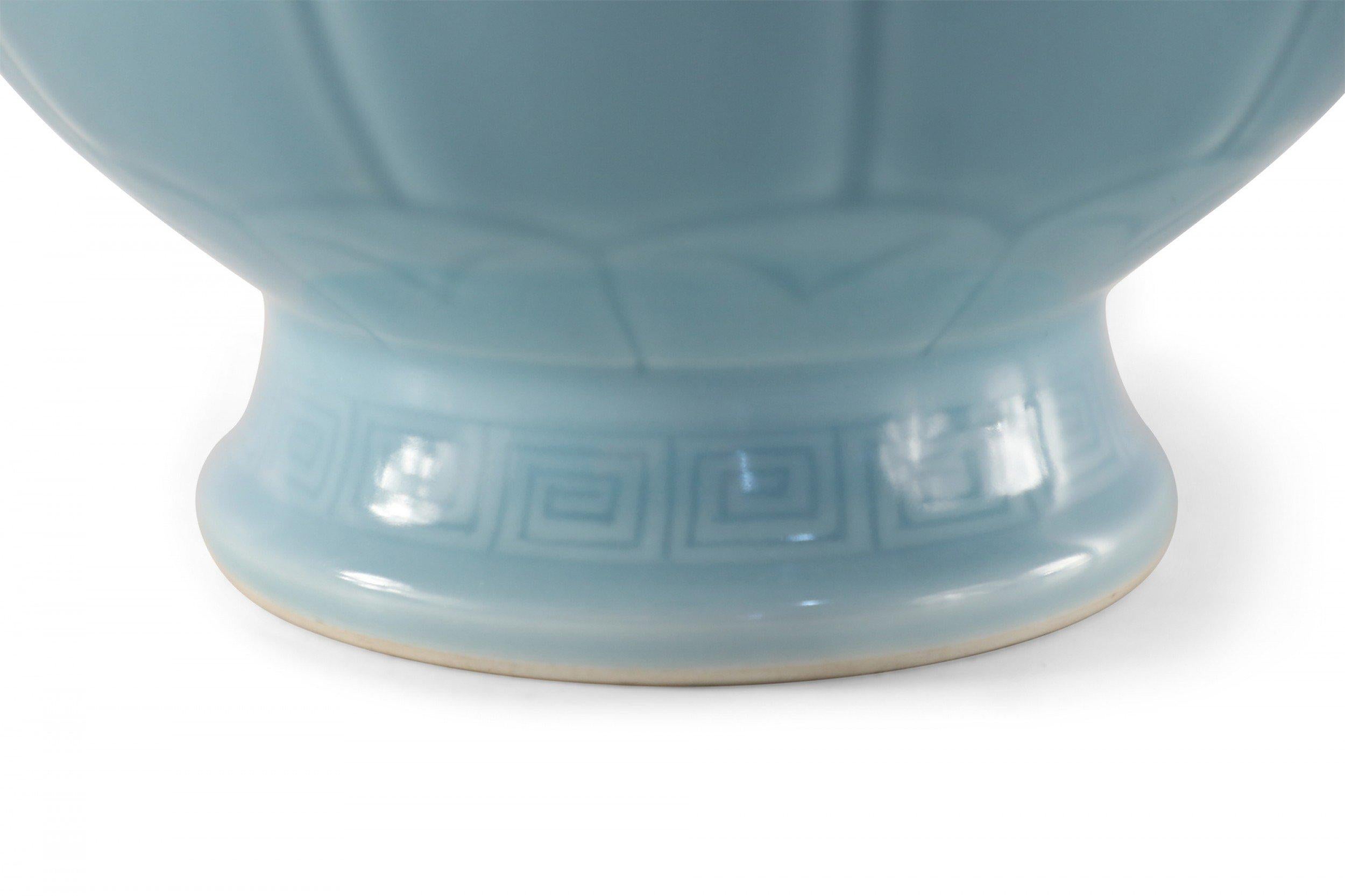 Chinese Qing Dynasty Qianlong period (20th century) porcelain vase in light blue, accented with a tonal pattern that emphasizes its globular shape and doorknocker ornamentation along the sides (date mark on bottom).
     