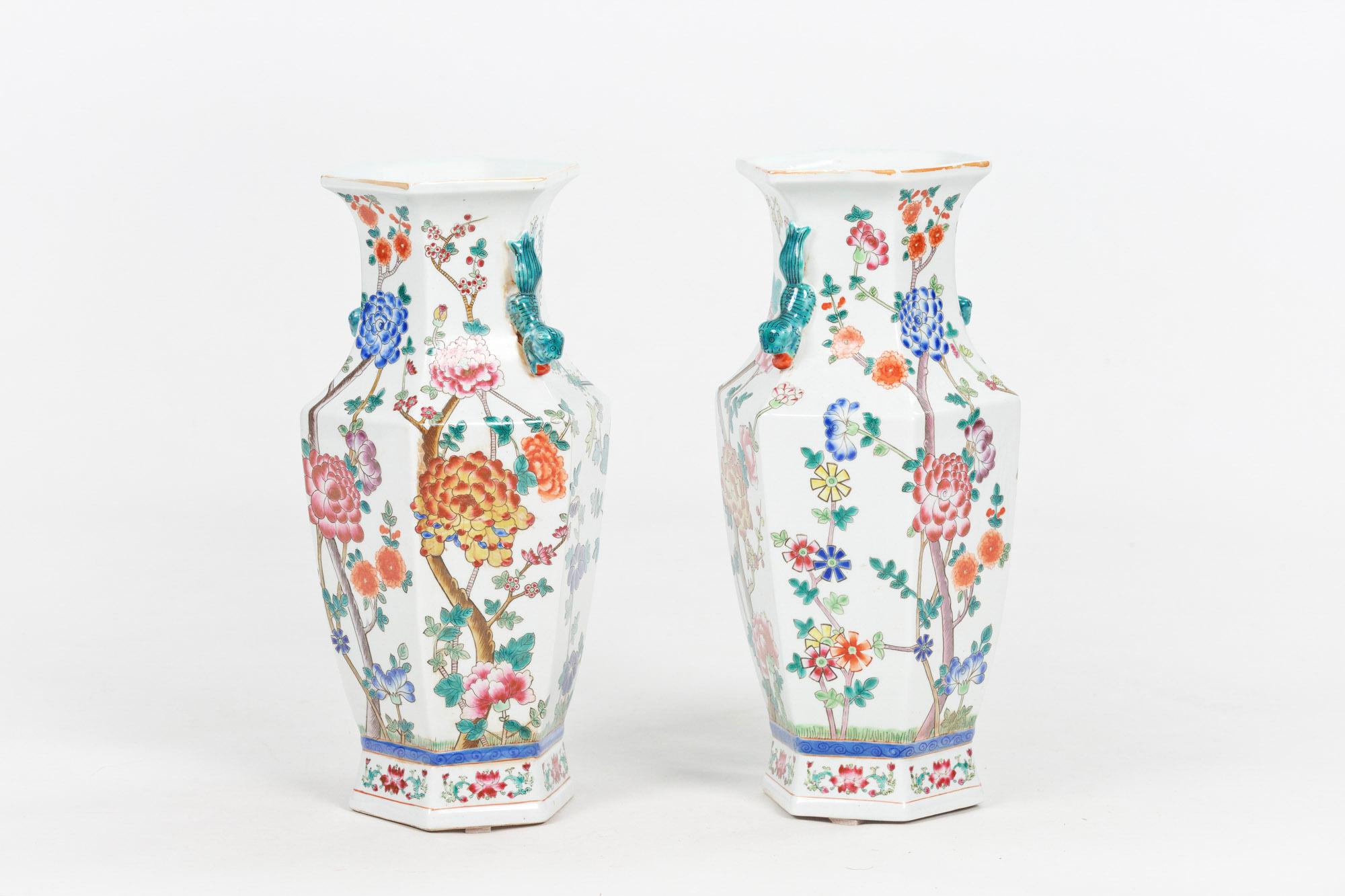Chinese Qing Dynasty pair of baluster vases of hexagonal form, the everted scalloped rim of white ground raised over tapering neck with pair of recumbent tigers in green glaze cast in high relief, the body with trees, foliate and flower head motif