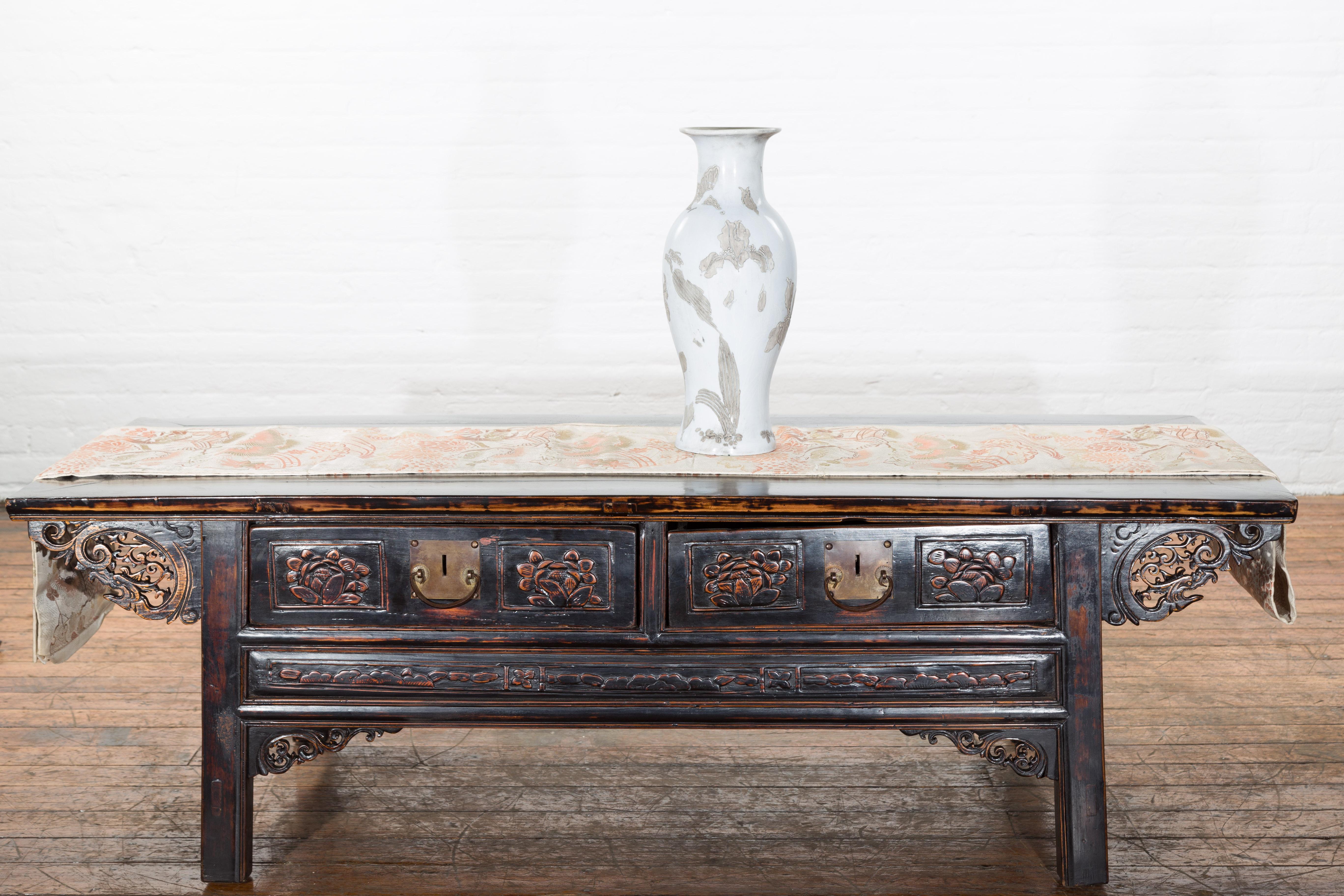 A Qing Dynasty antique altar vase from the 19th century with beautiful silver floral designs that decorate the bright white body of the entire antique porcelain vase. Our Qing Dynasty antique vase from China features a round, solid base that opens