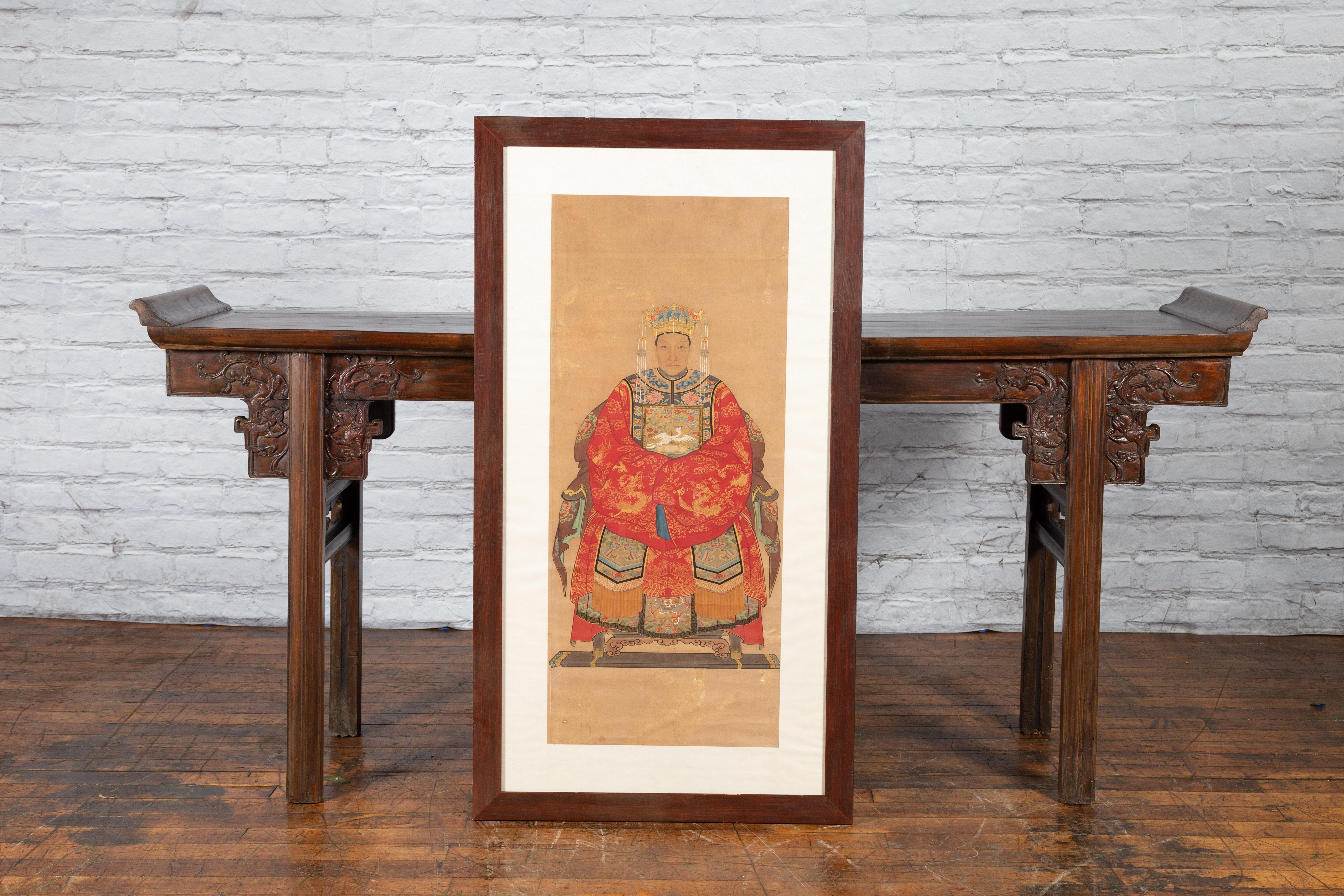 A Chinese Qing Dynasty period framed painting from the 19th century of an official's wife with bird-adorned buzi, painted on a linen canvas. Created in the North-Eastern province of Shanxi during the Qing dynasty, this 19th century painting