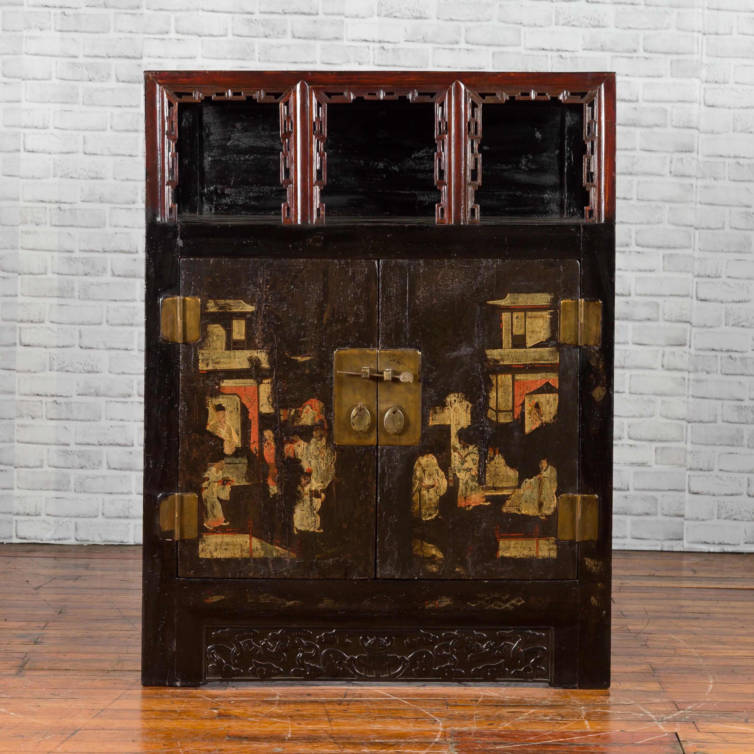 A Chinese Qing Dynasty period cabinet from the 19th century, with original finish and Chinoiserie motifs. Created in China during the Qing Dynasty period, this cabinet features a linear silhouette perfectly complimented by a dark brown lacquer. The