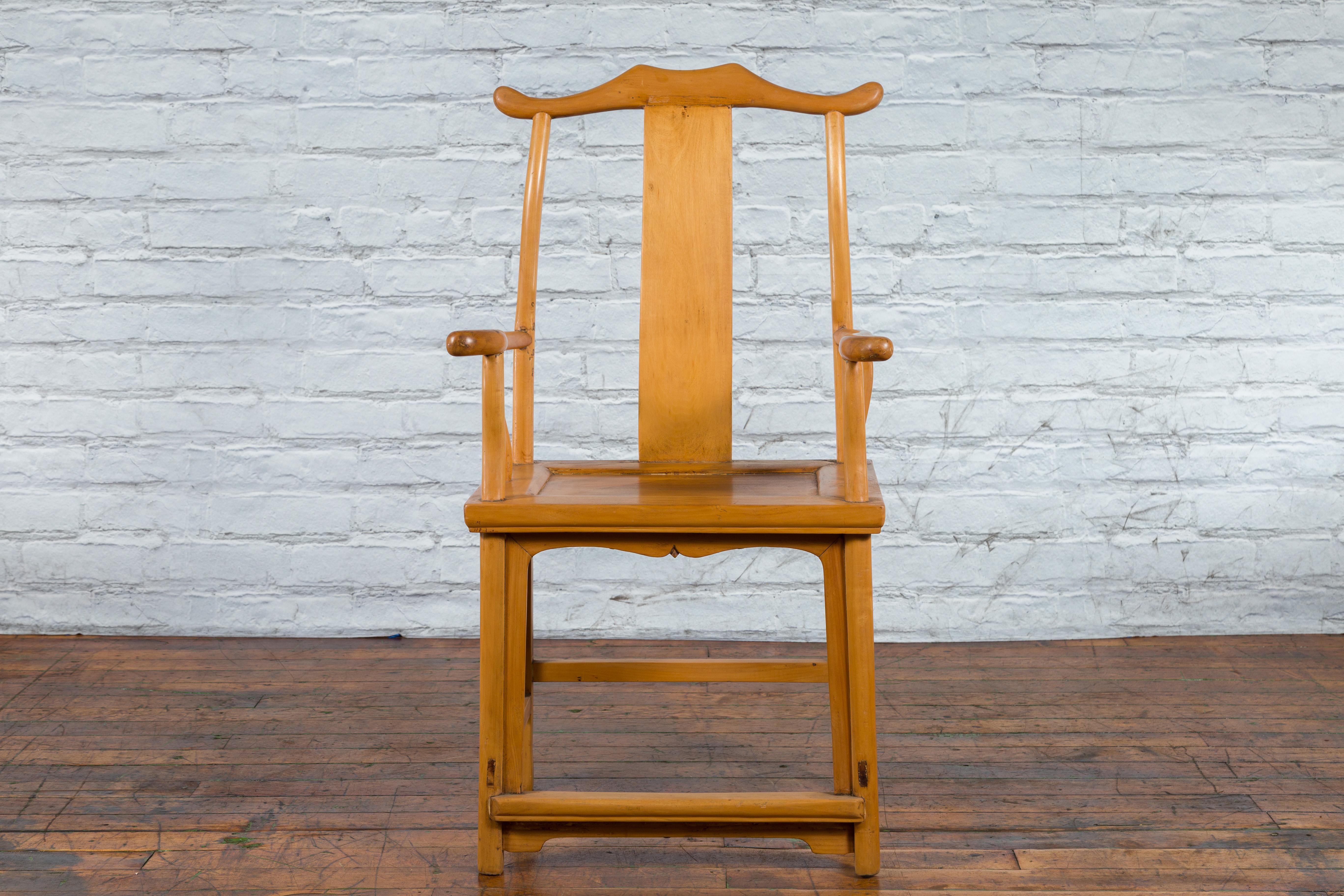 A Chinese Qing Dynasty period lamp hanger chair from the late 19th century, with serpentine arms, wooden seat and natural patina. Created in China during the later part of the Qing dynasty period in the late 19th century, this scholar's lamp-hanger