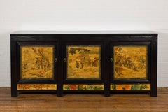 Low Yellow and Black Cabinet with Three Door Paintings