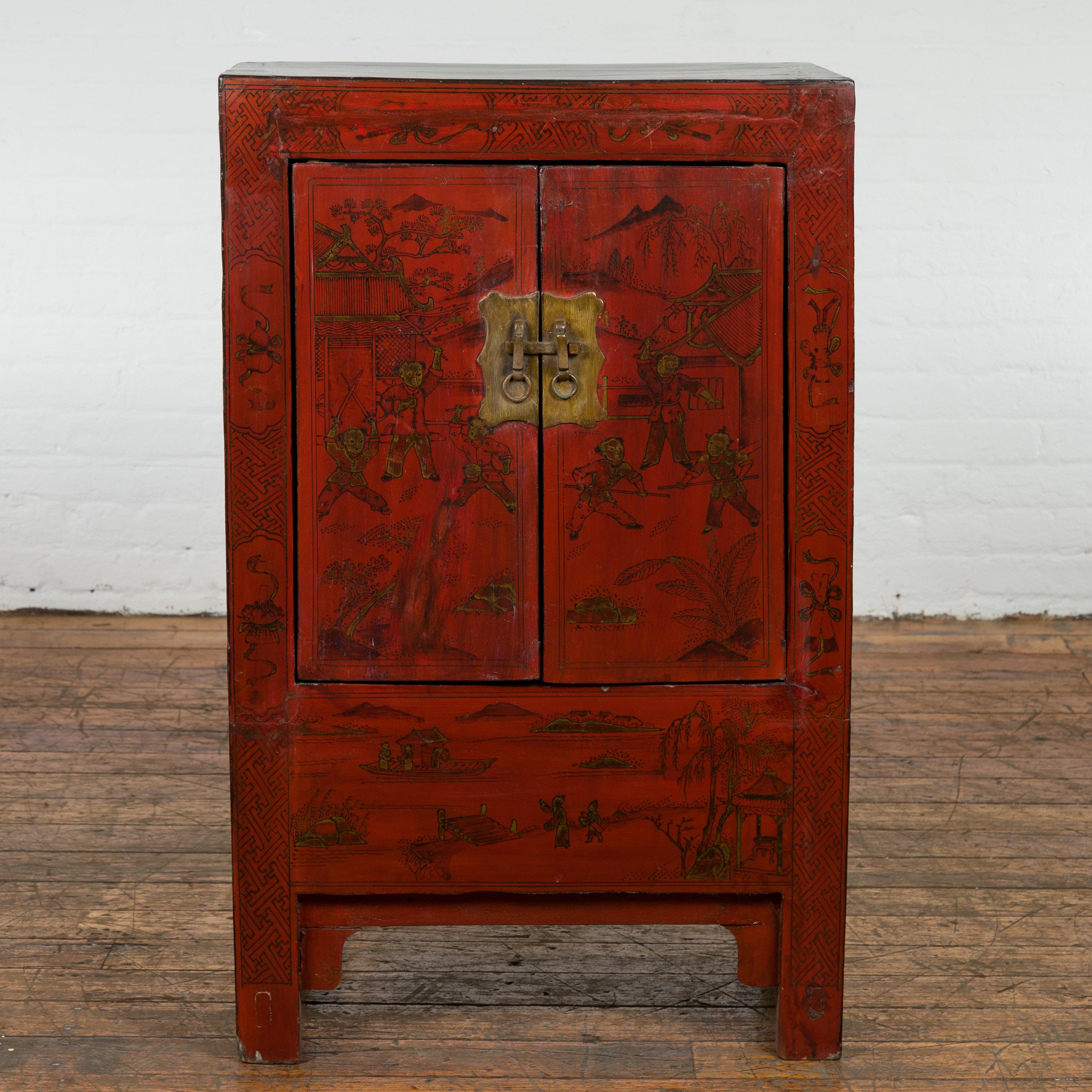 A Chinese Qing Dynasty period red lacquer bedside cabinet from the 19th century with hand-painted décor and golden highlights. Showcasing stunning craftsmanship and artistic vision, this 19th century Qing Dynasty red lacquer bedside cabinet from