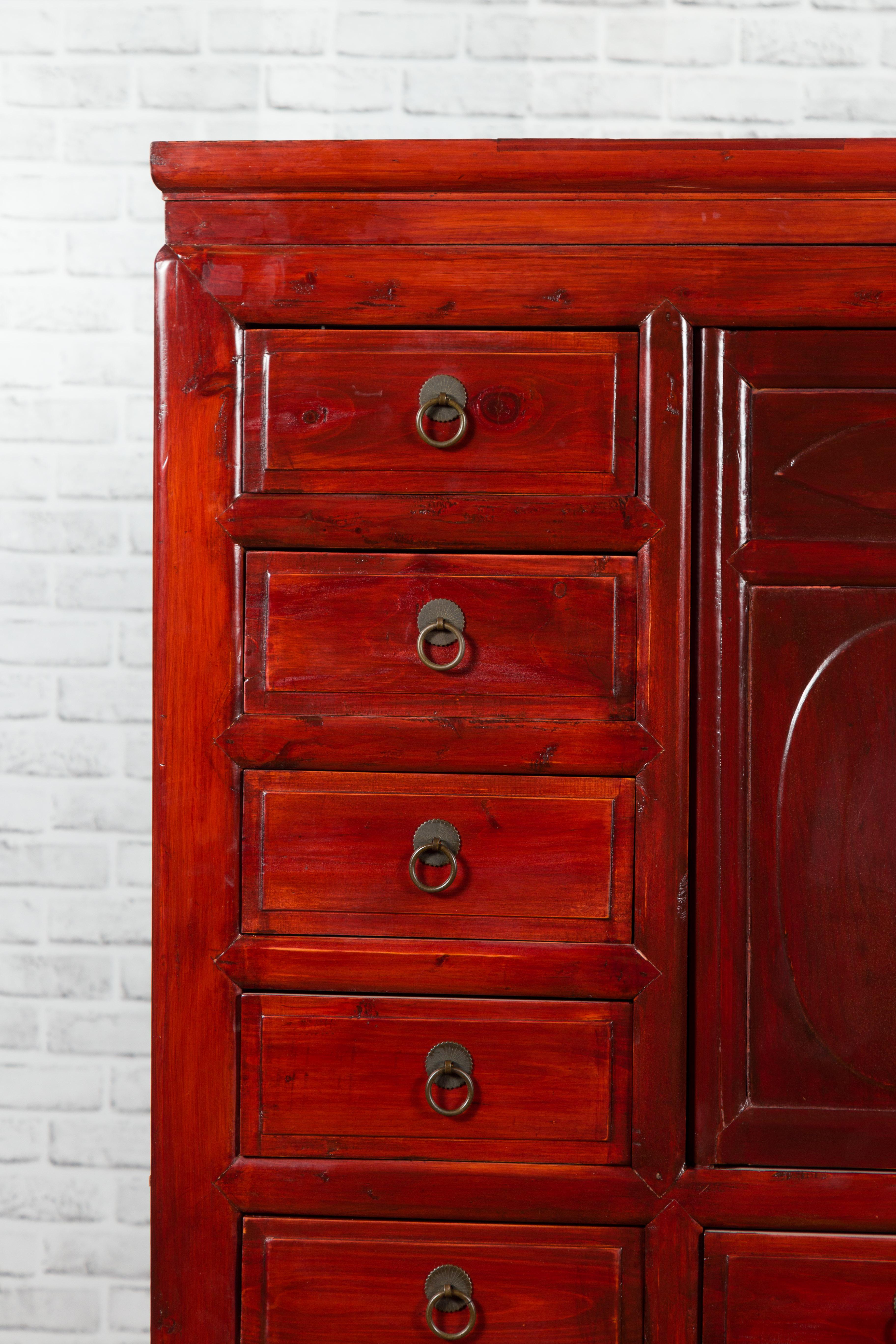 Wood Chinese 1930s Red Lacquered Apothecary Cabinet with 32 Drawers and Carved Panels For Sale