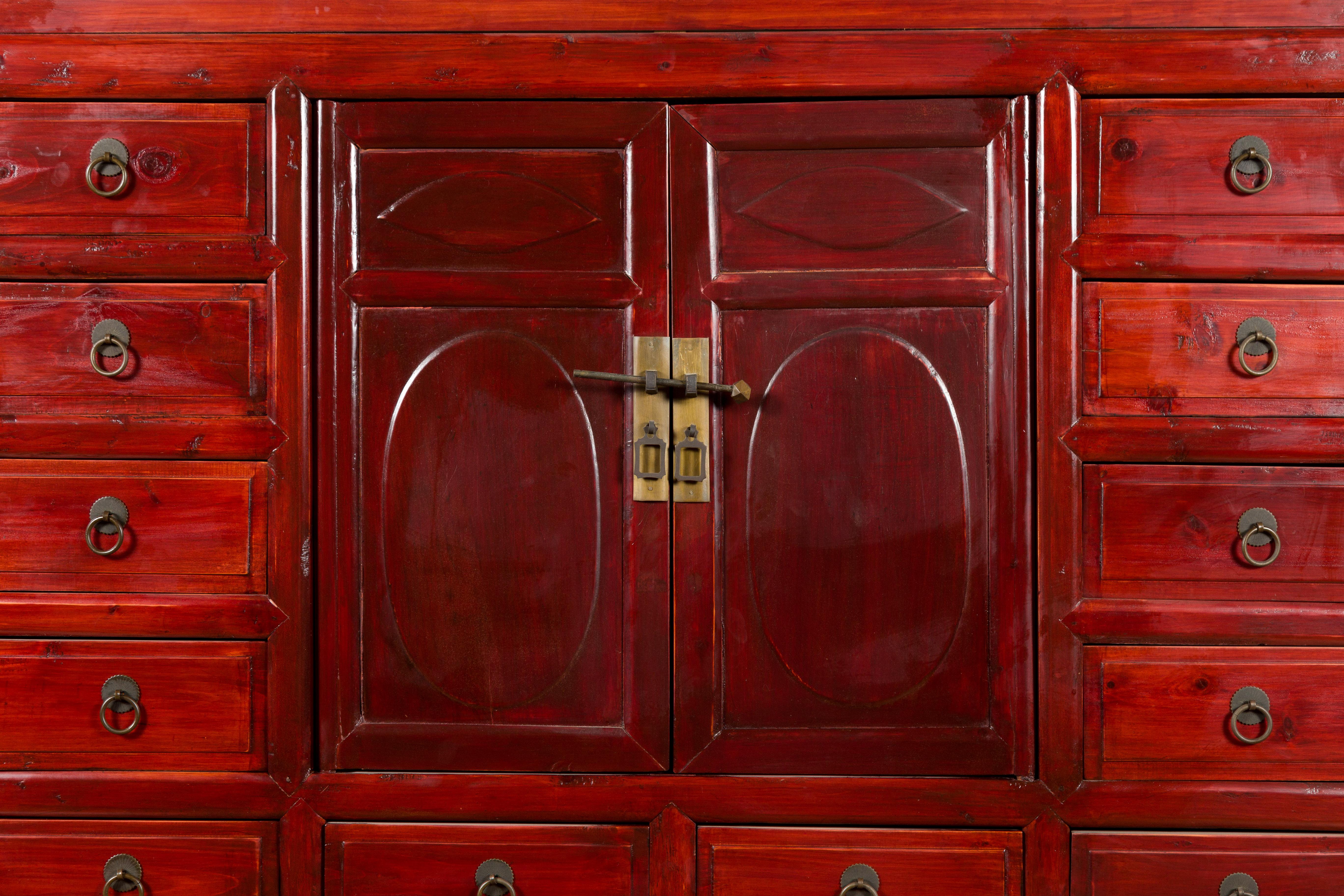 Chinese 1930s Red Lacquered Apothecary Cabinet with 32 Drawers and Carved Panels For Sale 1