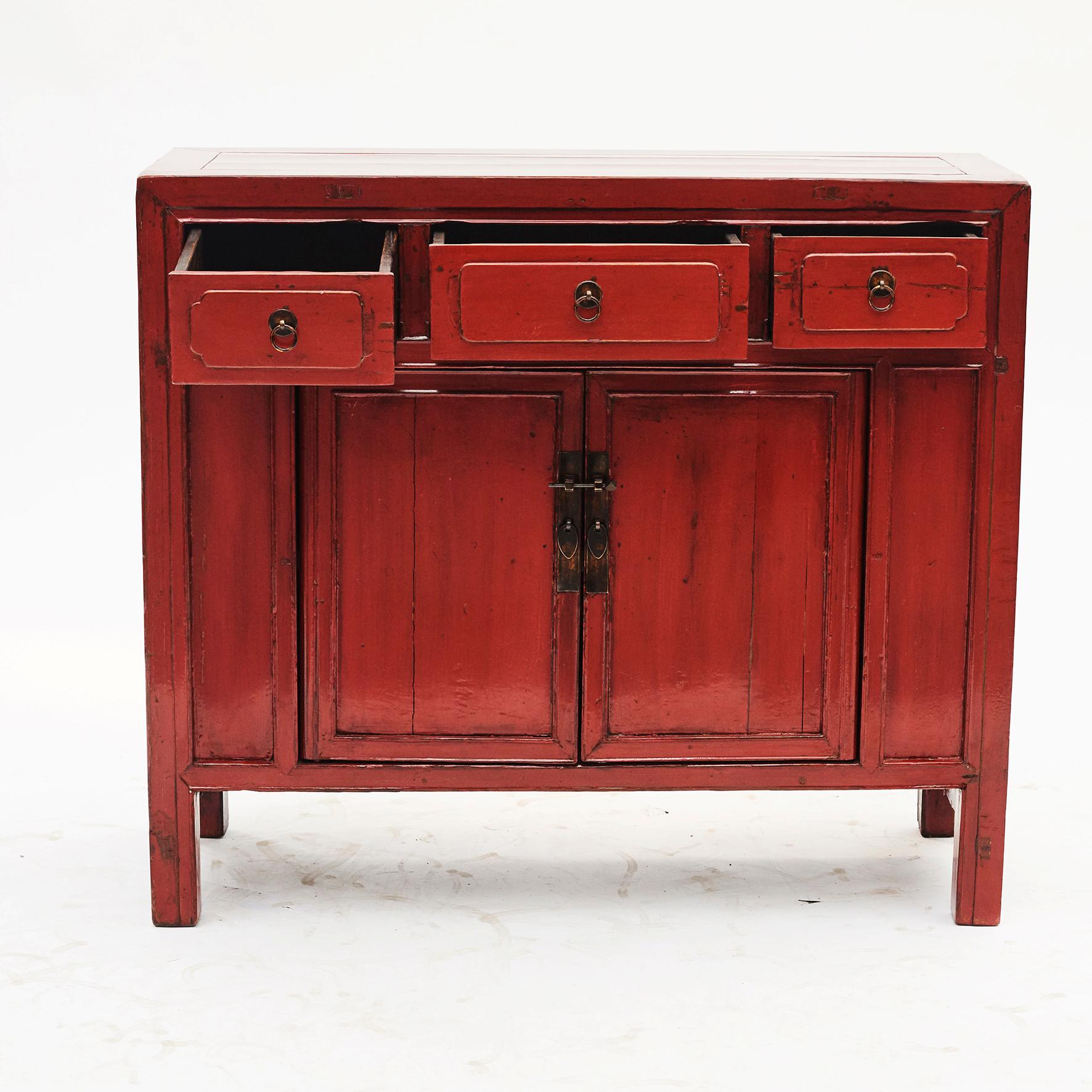 Antique basswood two-door cabinet with 3 drawers. Each drawer is adorned with ring pulls with circular back plates.
Original red lacquer. Natural patina and well-preserved lacquer color.
Jiangsu Province, China, circa 1880.