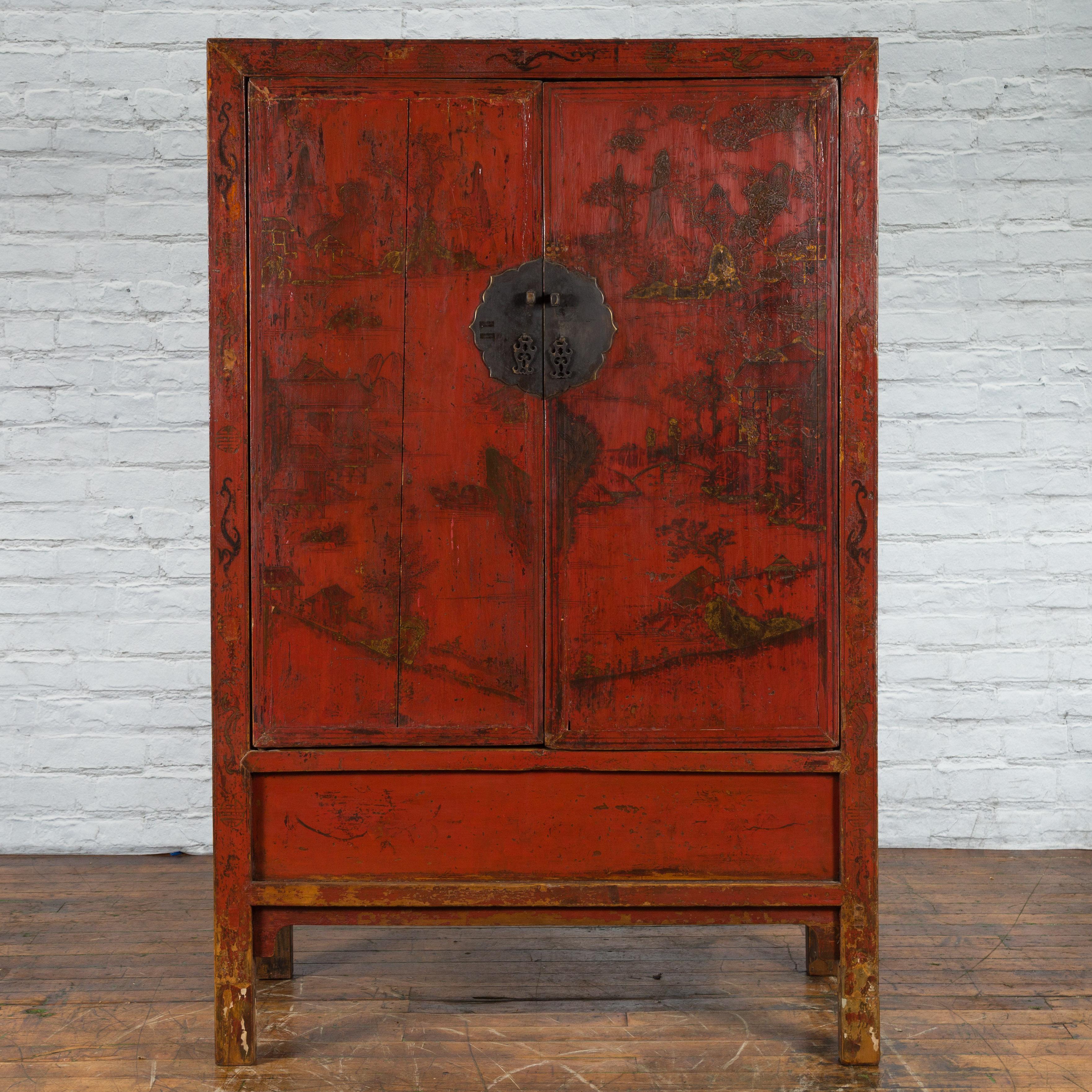 A Chinese Qing Dynasty period red lacquer cabinet from the 19th century, with hand-painted gilt motifs. Created in China during the Qing Dynasty in the 19th century, this wooden cabinet features a linear silhouette perfectly complimented by a red