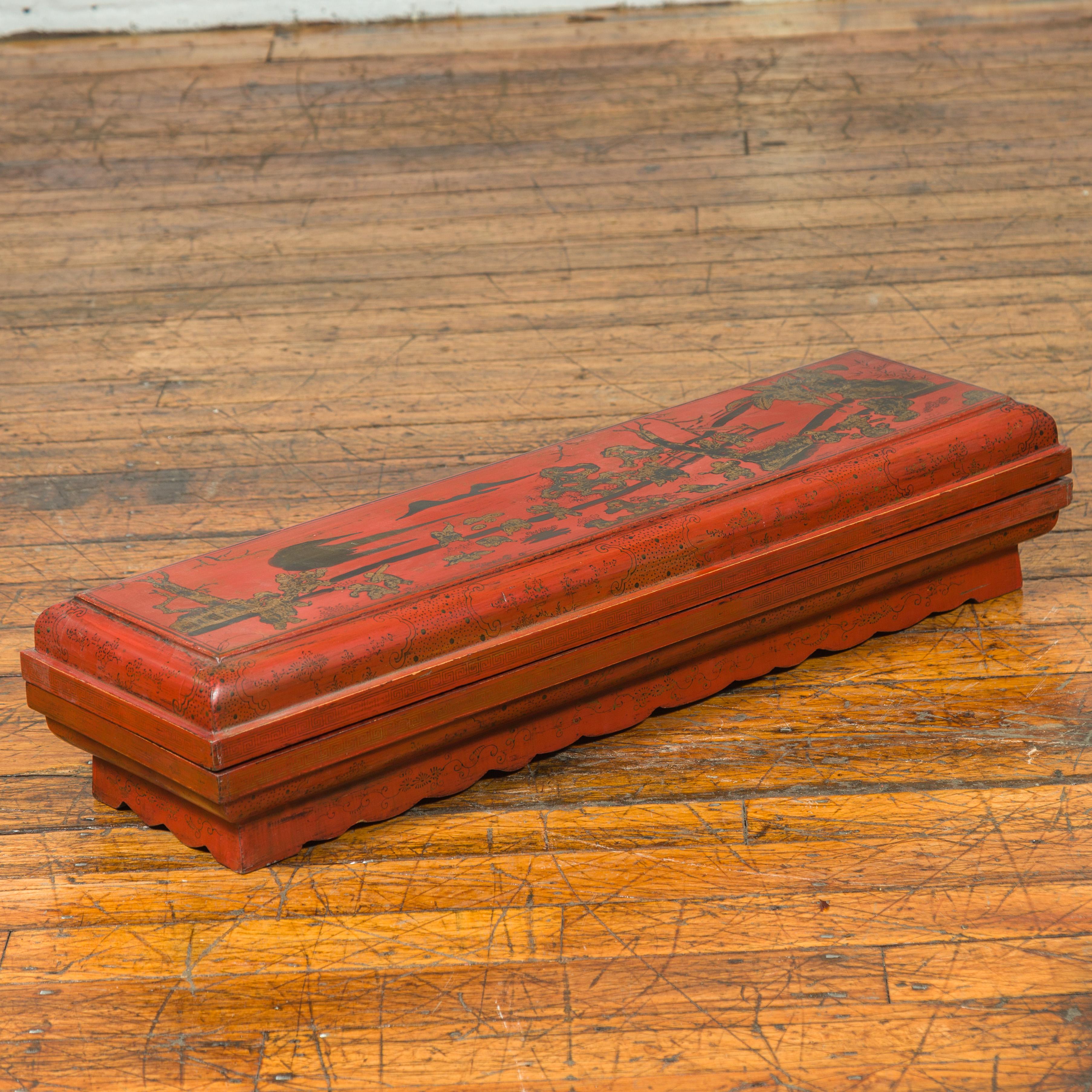 A Chinese Qing dynasty red lacquered lidded scroll box from the 19th century with distressed gold chinoiserie motifs. This exquisite Chinese Qing dynasty red lacquered lidded scroll box from the 19th century captivates with its rich historical charm