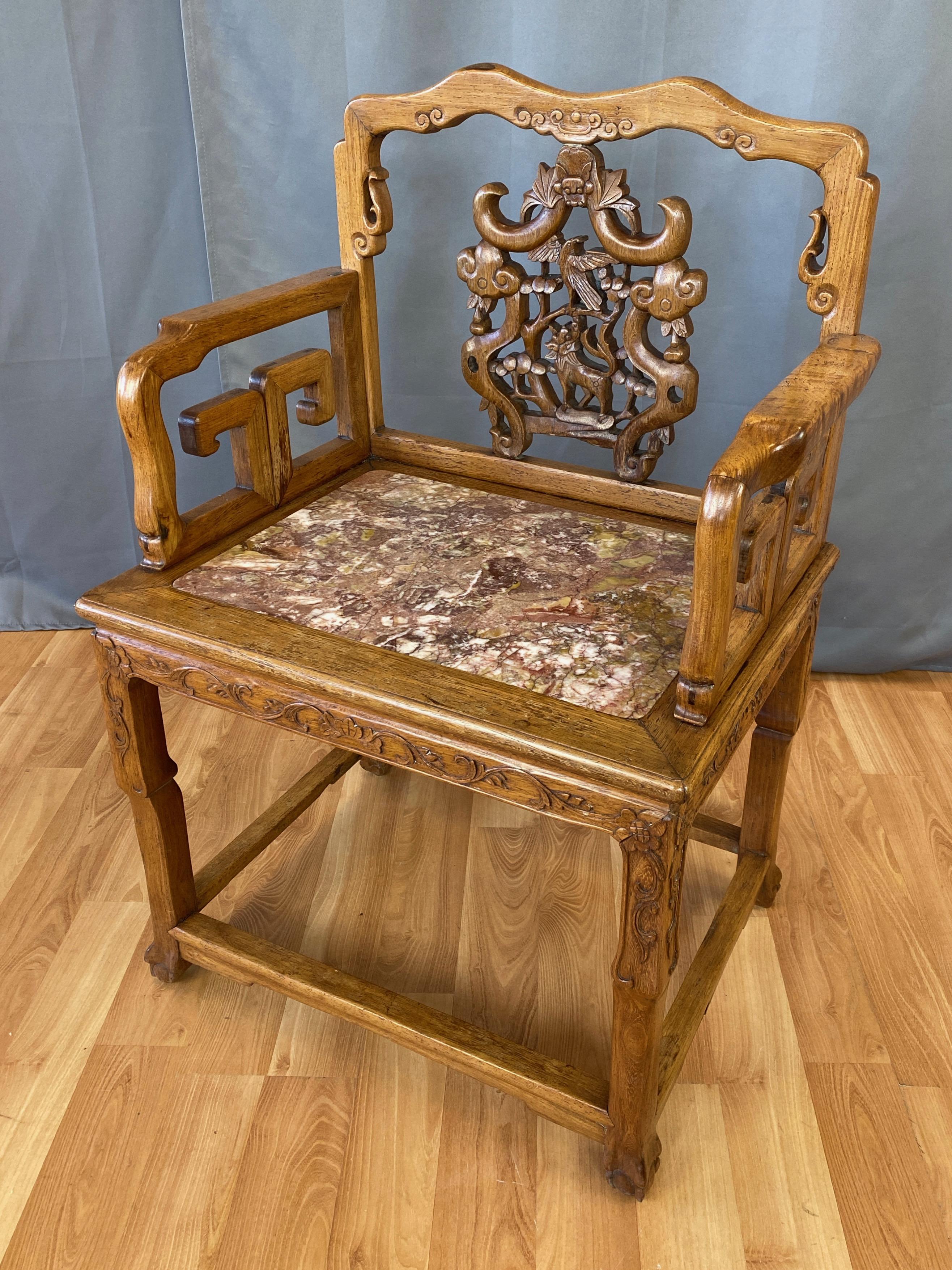 A very fine 19th century Chinese Qing dynasty solid rosewood armchair or lounge chair with marble seat.

Distinguished by a hand-carved pierced back splat with lively flora & fauna motif that’s topped by a bat, the traditional symbol for longevity,