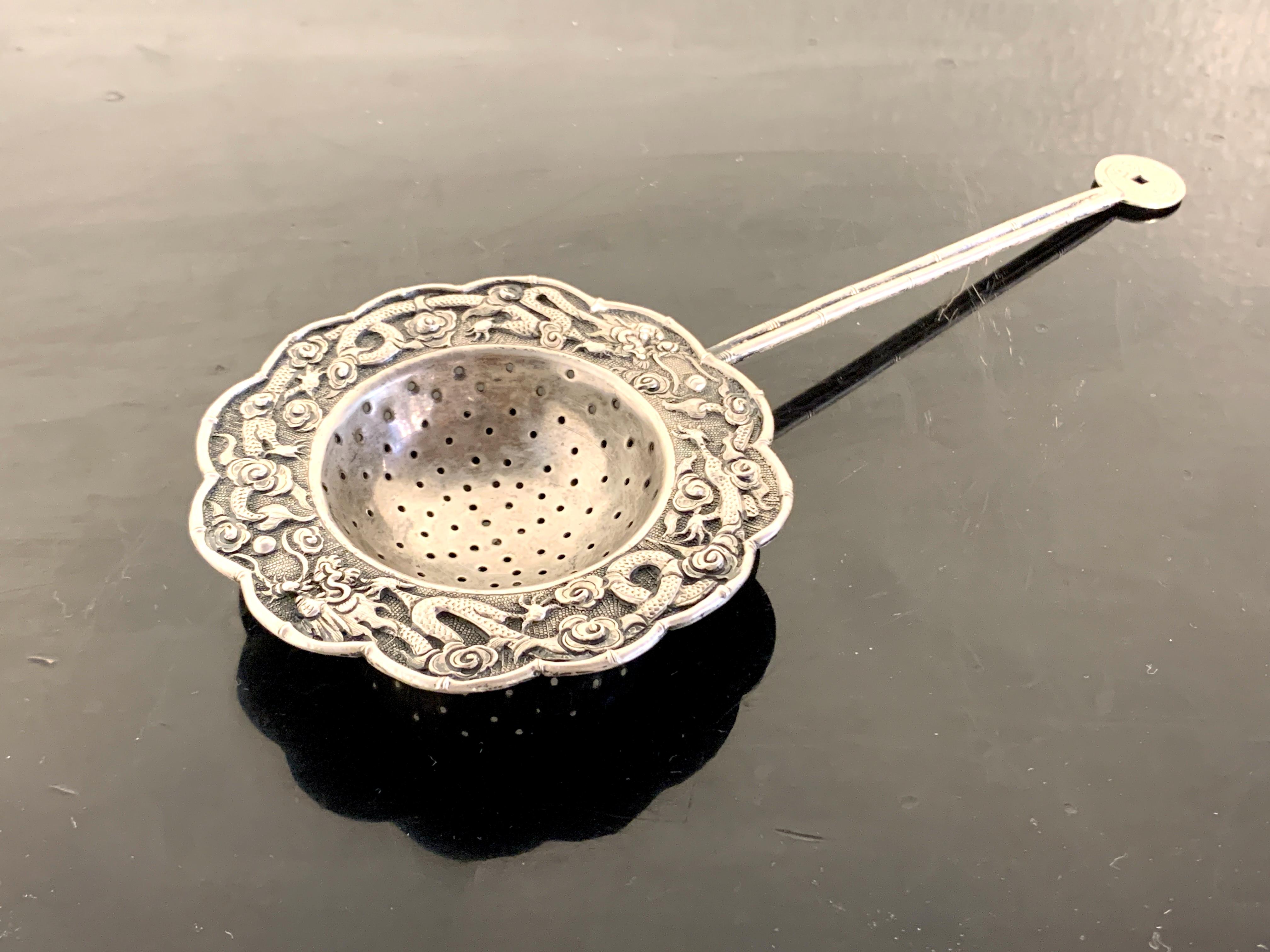 A wonderful Chinese silver tea strainer, Qing Dynasty, possibly Tong Zhi period (1861 to 1875), late 19th century, China. 

The silver tea strainer elegantly designed with a bamboo motif handled topped by a faux 