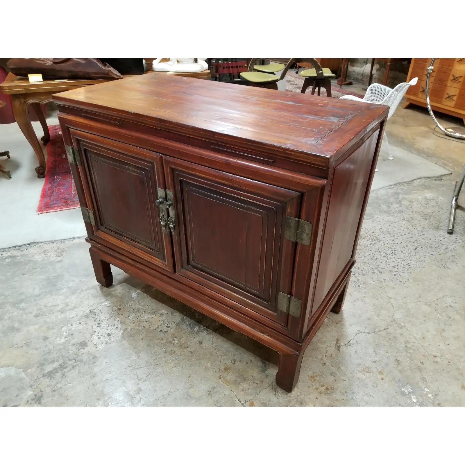 Antique Chinese Qing Dynasty two-door storage cabinet, circa. 1900. Beautiful original finish with nice glow and patina. Notice wonderful highlights to finish at high points of cabinetry. Unusual 