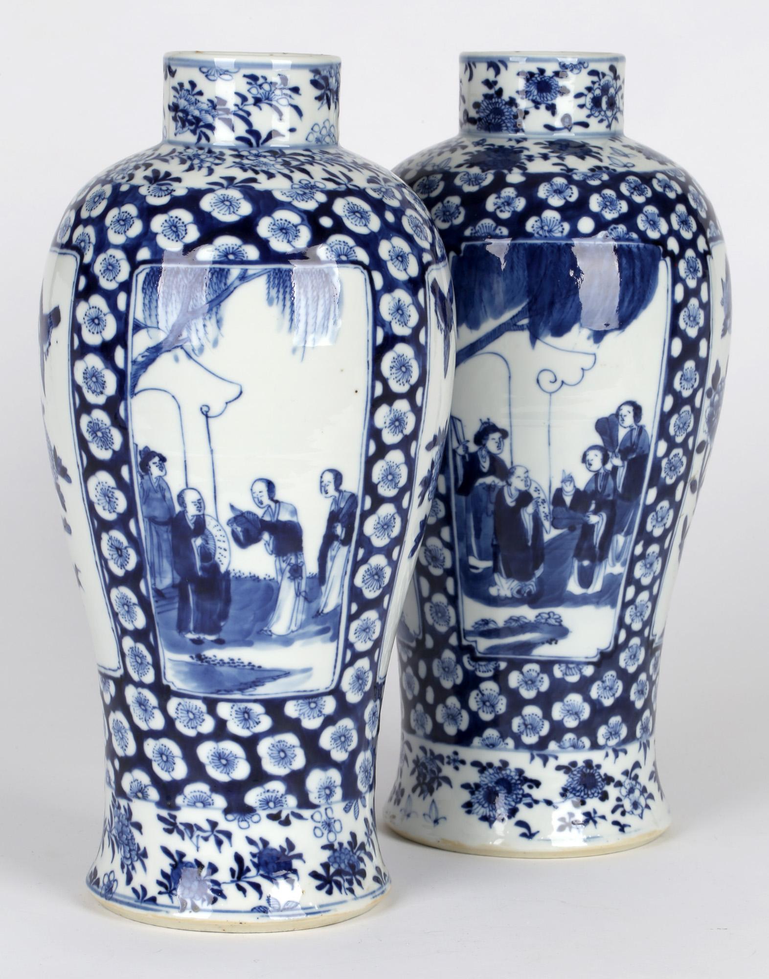 An impressive and large pair Chinese Qing Kangxi mark blue and white vases painted with panels with birds and figures and dating from the 19th century. These tall bulbous shaped porcelain vases stand on a rounded unglazed foot with recessed bases