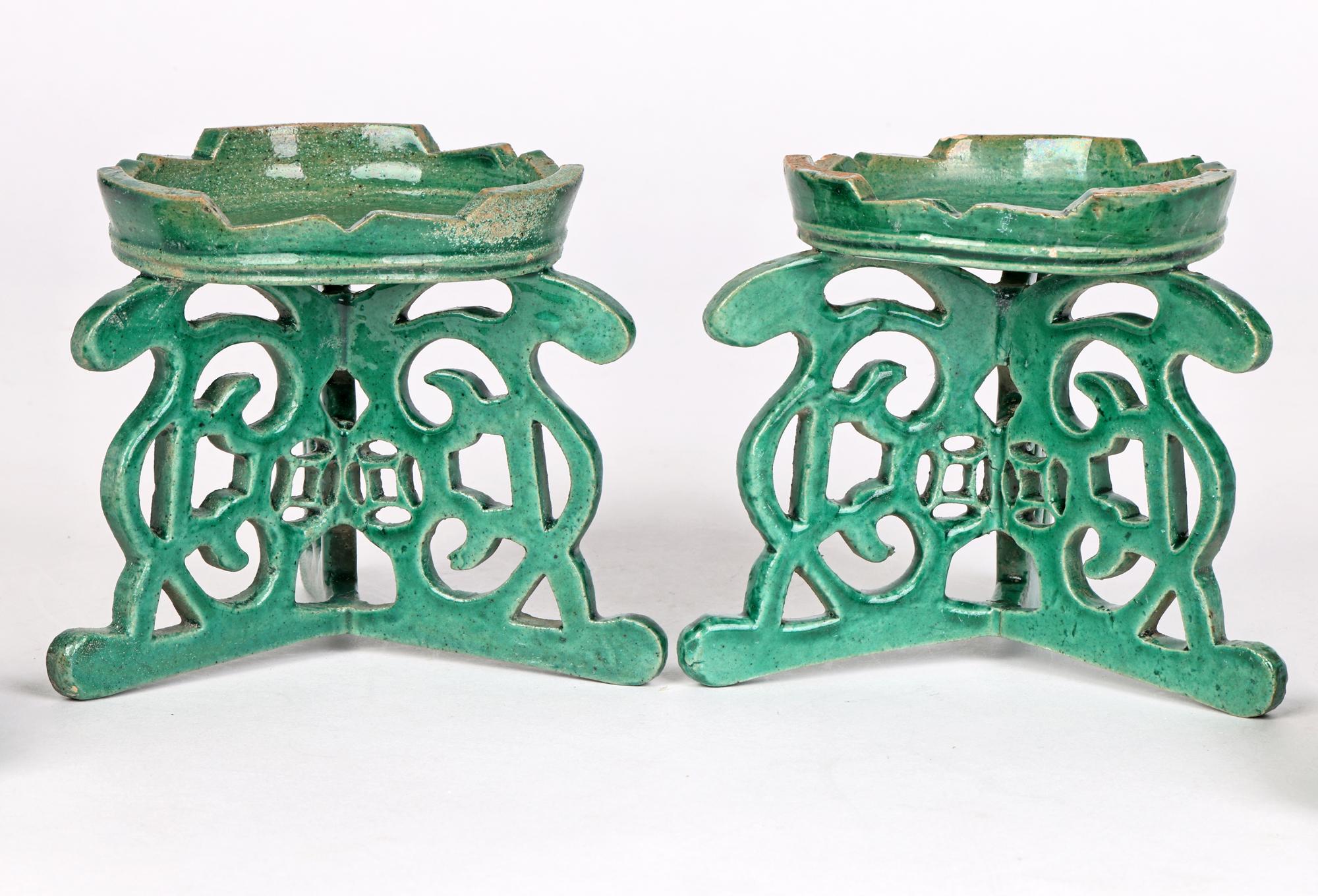 A fine pair antique Chinese qing green glazed pottery altar stands and dishes dating from the 19th century, possibly earlier. The stands are of circular shape, possibly for candles, and are mounted on a three legged pierced stand with scroll