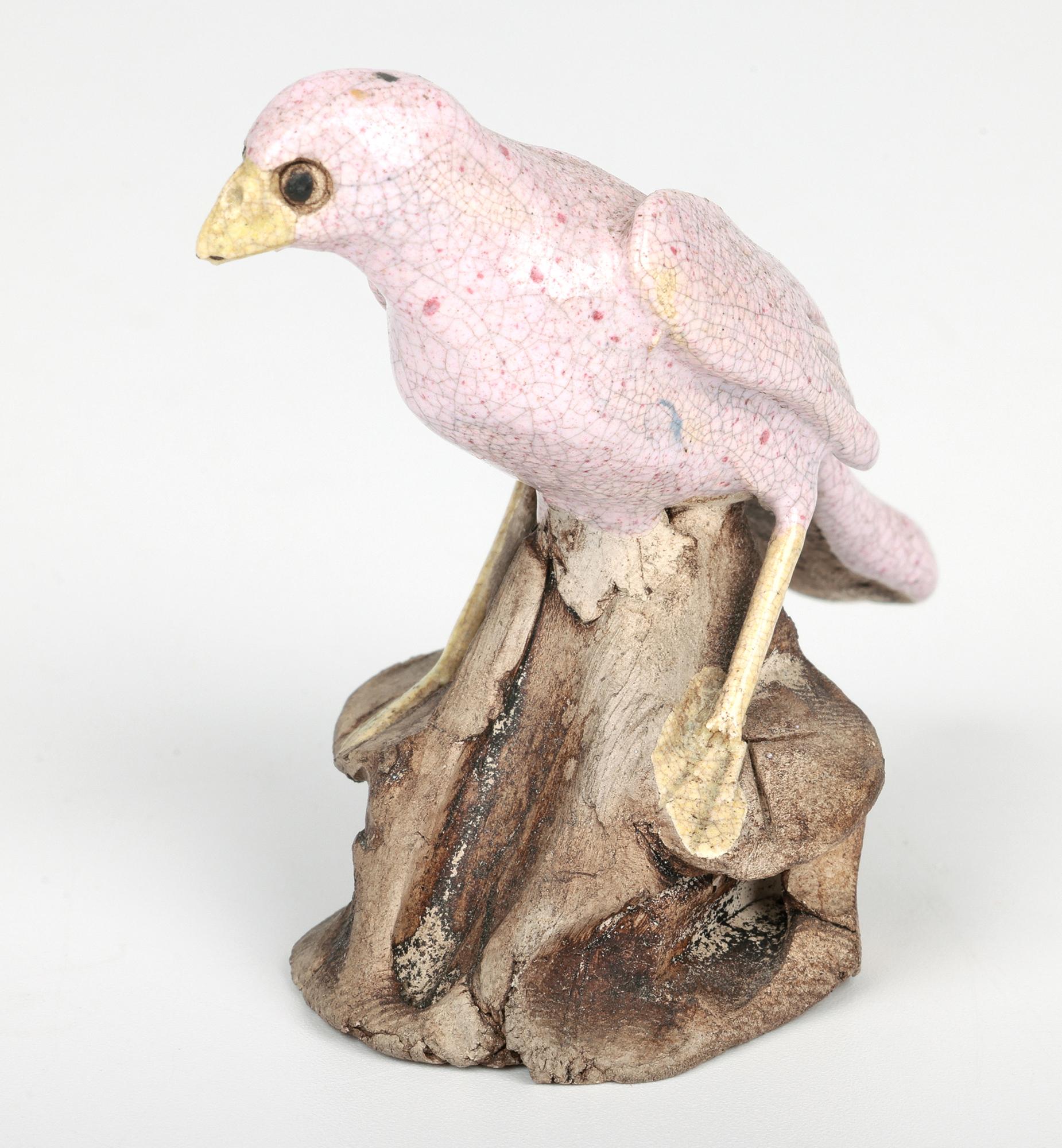 A delightful pair Chinese Qing birds perched on rocks originating from the Guangdong Province in China and dating from the 18th or early 19th century. The hand-crafted stoneware birds appear to be wading birds with long legs are both perched a