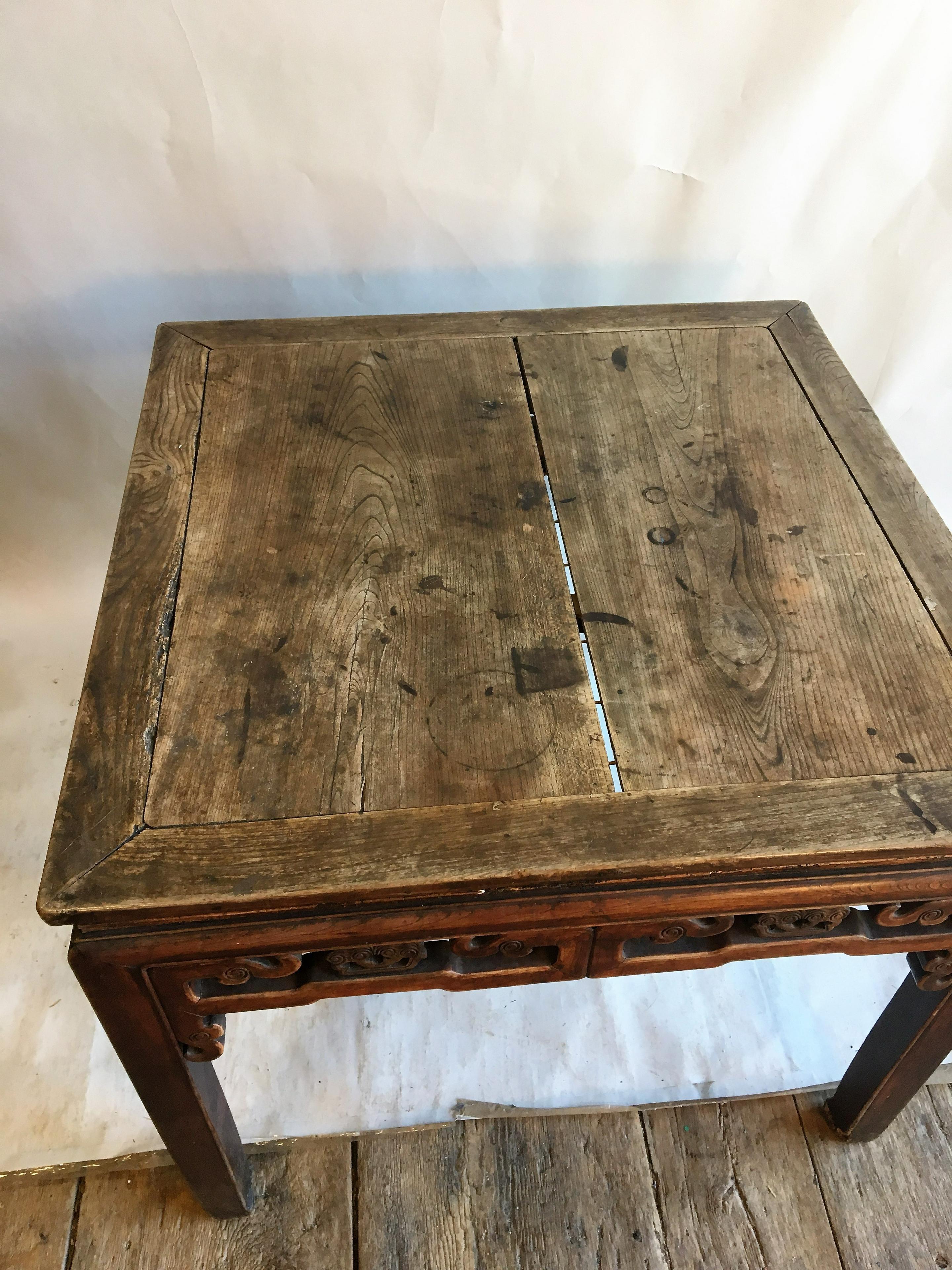 A square games table, in elm with carvings on apron below the top, on straight legs, Chinese Qing period, mid-19th century. Measures: 37
