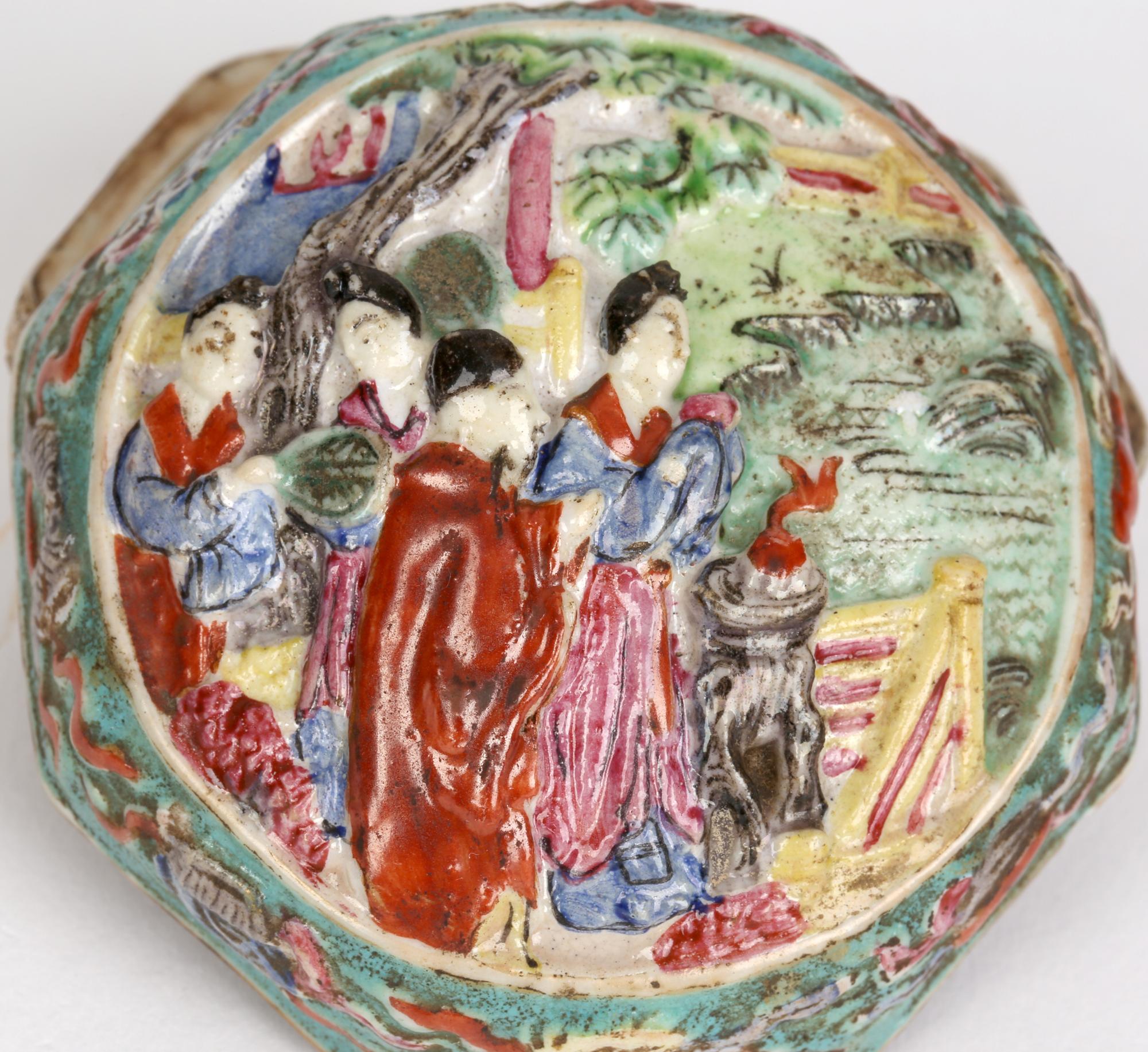 A stylish Antique Chinese Qing hexagonal shaped porcelain lidded box decorated in relief with figures and other Chinese symbols dating from the 19th century. The box stands on a rounded base the lower body relief molded with bats amidst flower