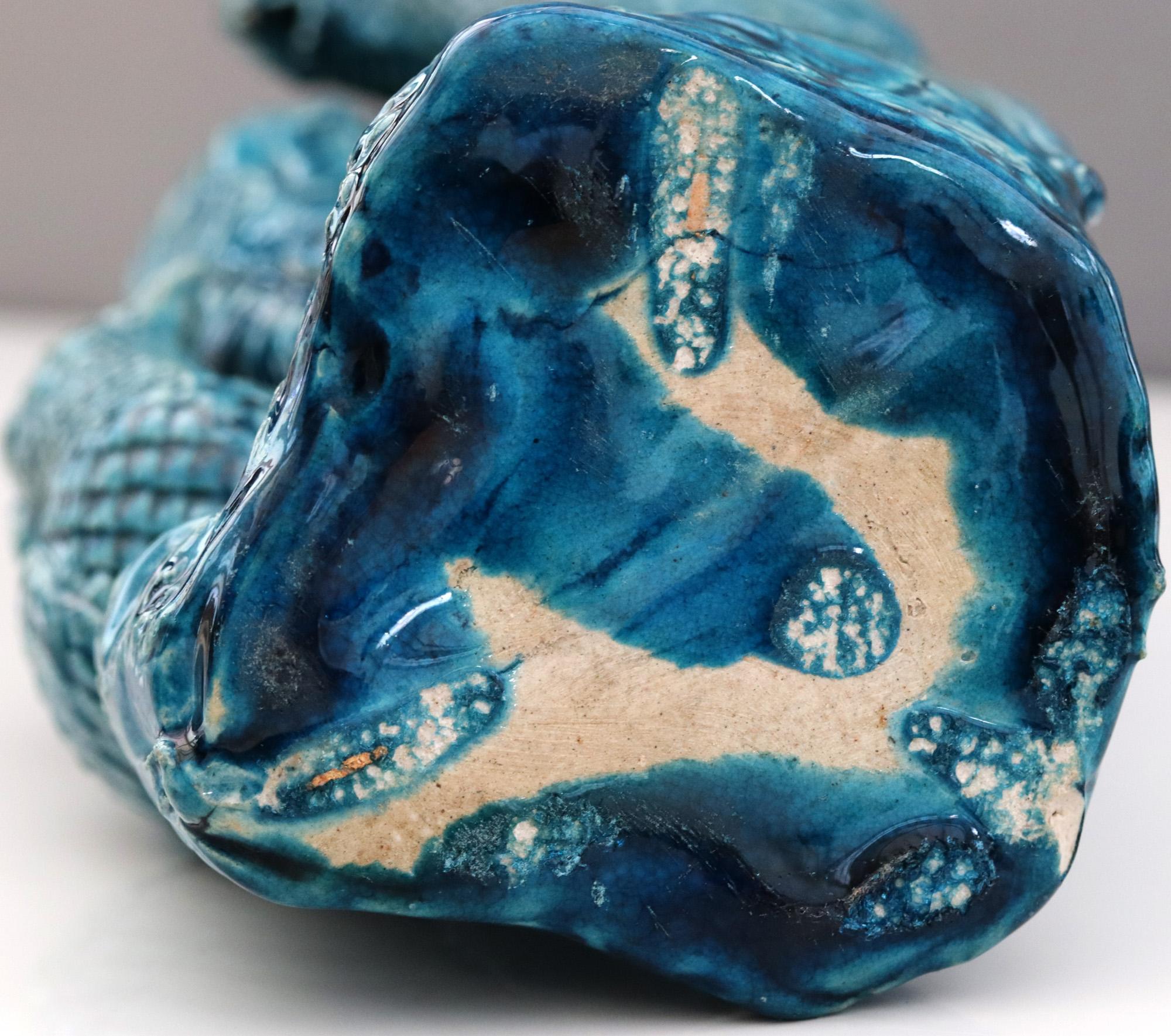 A striking Chinese Qing vase modelled with courting birds perched on a tree trunk decorated in monochrome turquoise blue glazes and dating from the 19th century. The vase probably made in biscuit porcelain is heavily potted with a male and female