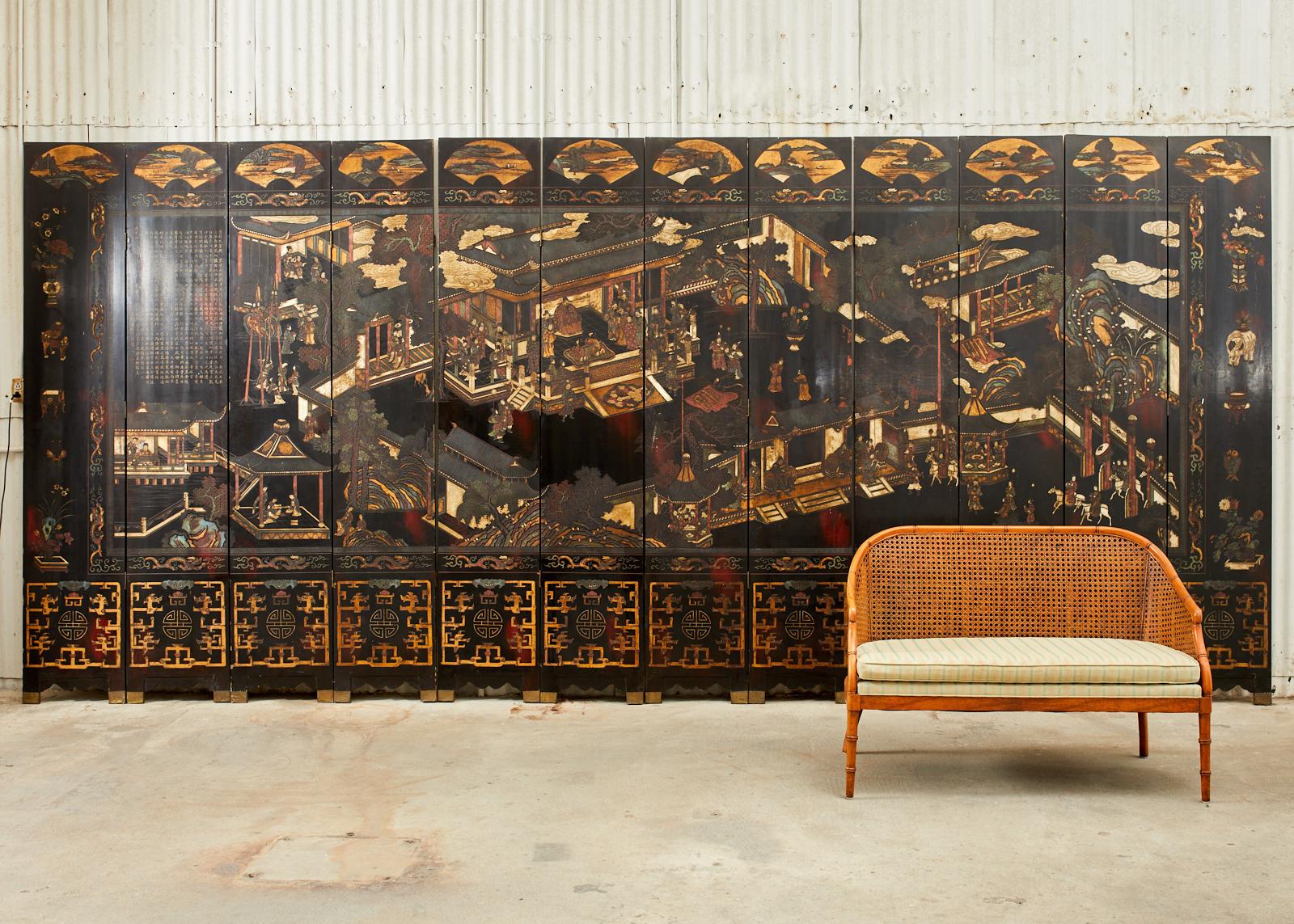 Early 20th century Chinese late Qing dynasty twelve panel lacquered coromandel screen. The grand screen features a royal pavilion courtyard with figures. Each panel measures 17.5 inches wide with thick lacquer. Intricately carved and incised with