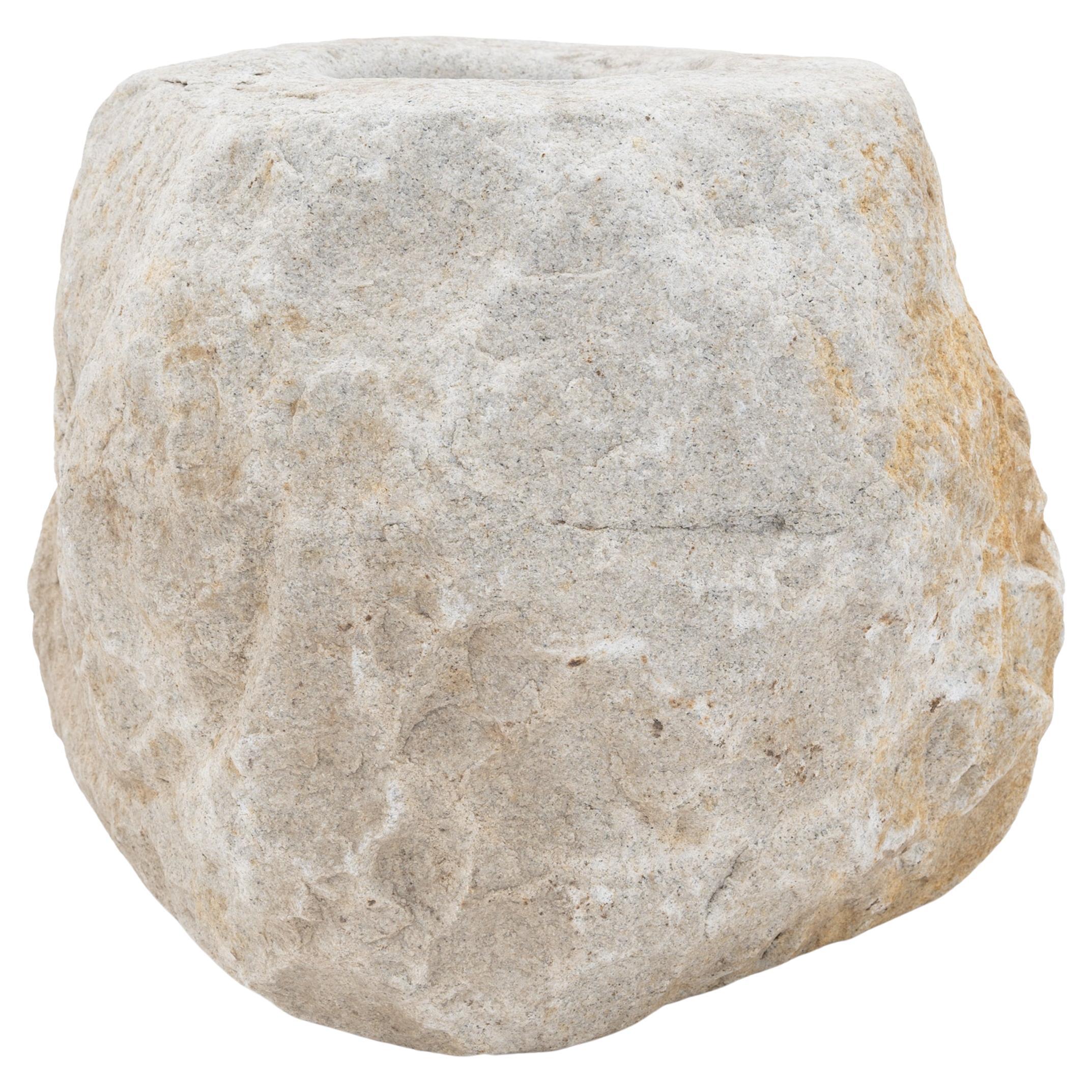 This stone mortar from the early 20th century was once used in a provincial kitchen to grind herbs, spices, rice, and other foods. Hand-carved from a solid block of limestone, the mortar has a minimally worked form that preserves the natural beauty