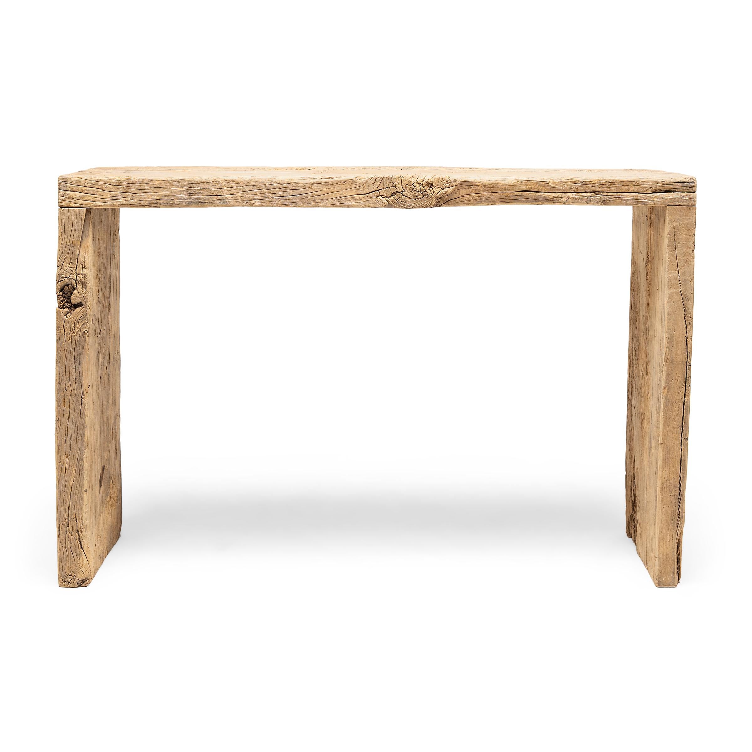 This contemporary console table is a celebration of wabi-sabi style. Crafted of wood reclaimed from Qing-dynasty architecture, the table has a minimalist waterfall design and is left unfinished to preserve the natural beauty of its materials.