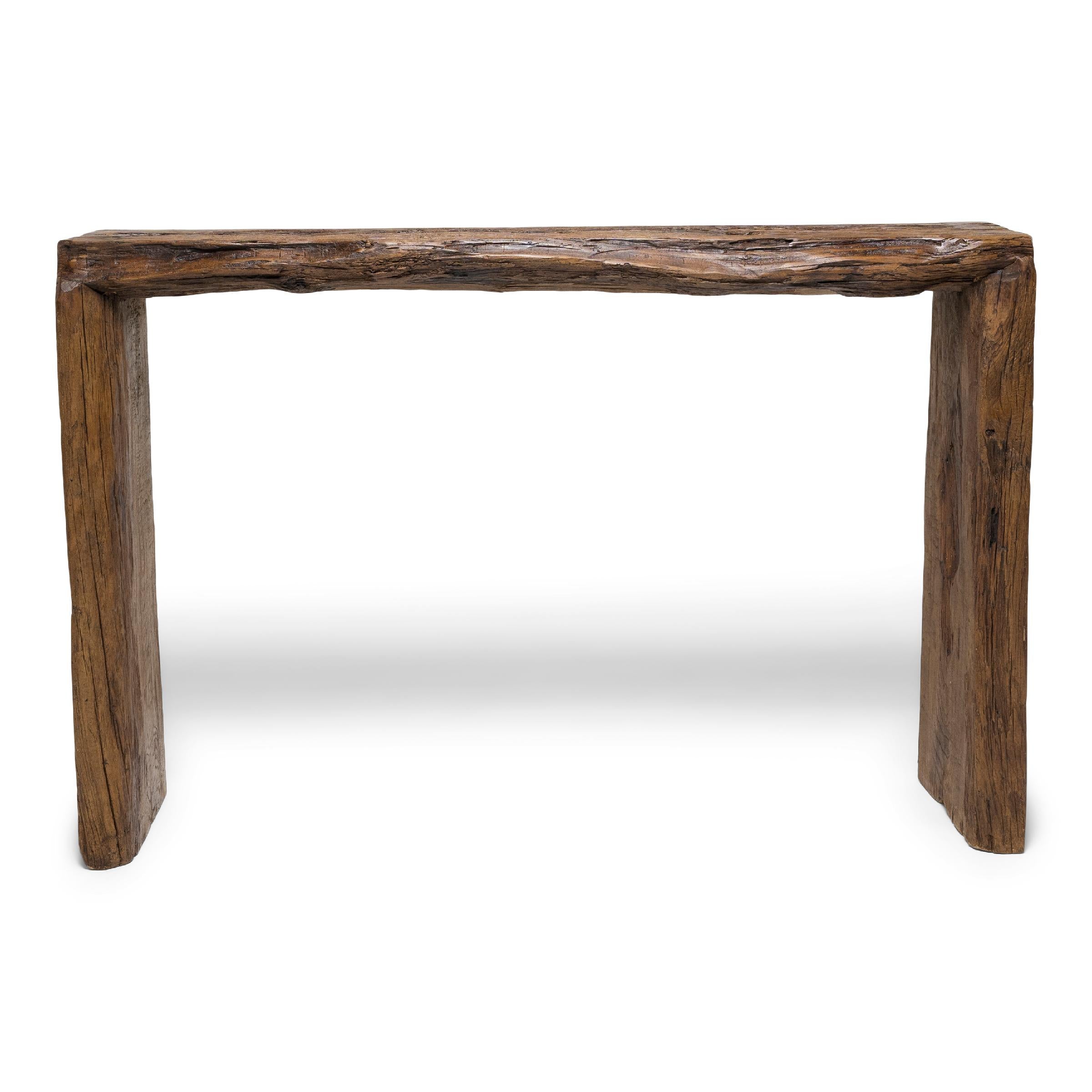 This contemporary console table is a celebration of wabi-sabi style. Crafted of wood reclaimed from Qing-dynasty architecture, the table has a minimalist waterfall design with dovetailed corners that recreate traditional joinery methods and add