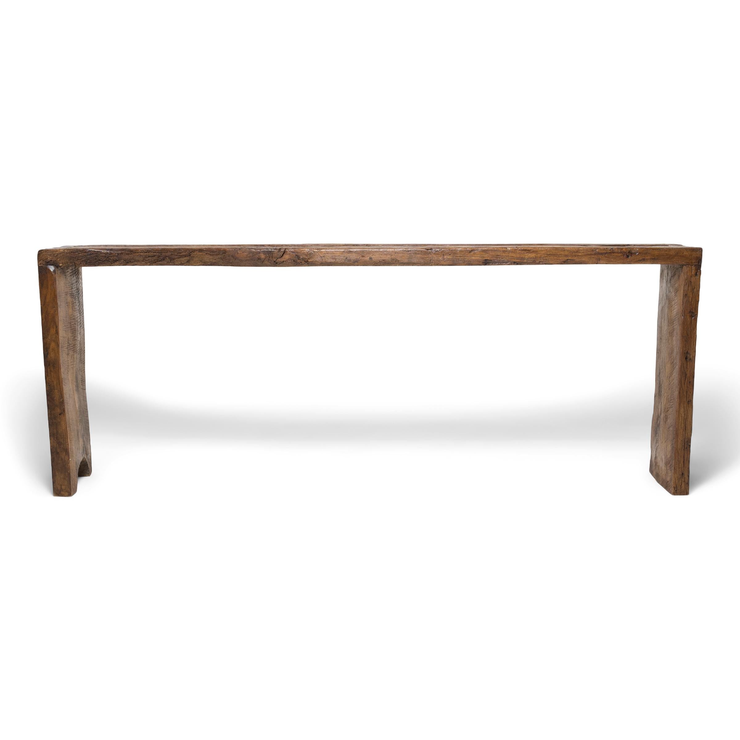 This contemporary console table is a celebration of wabi-sabi style. Crafted of wood reclaimed from Qing-dynasty architecture, the table has a minimalist waterfall design with dovetailed corners that recreate traditional joinery methods and add