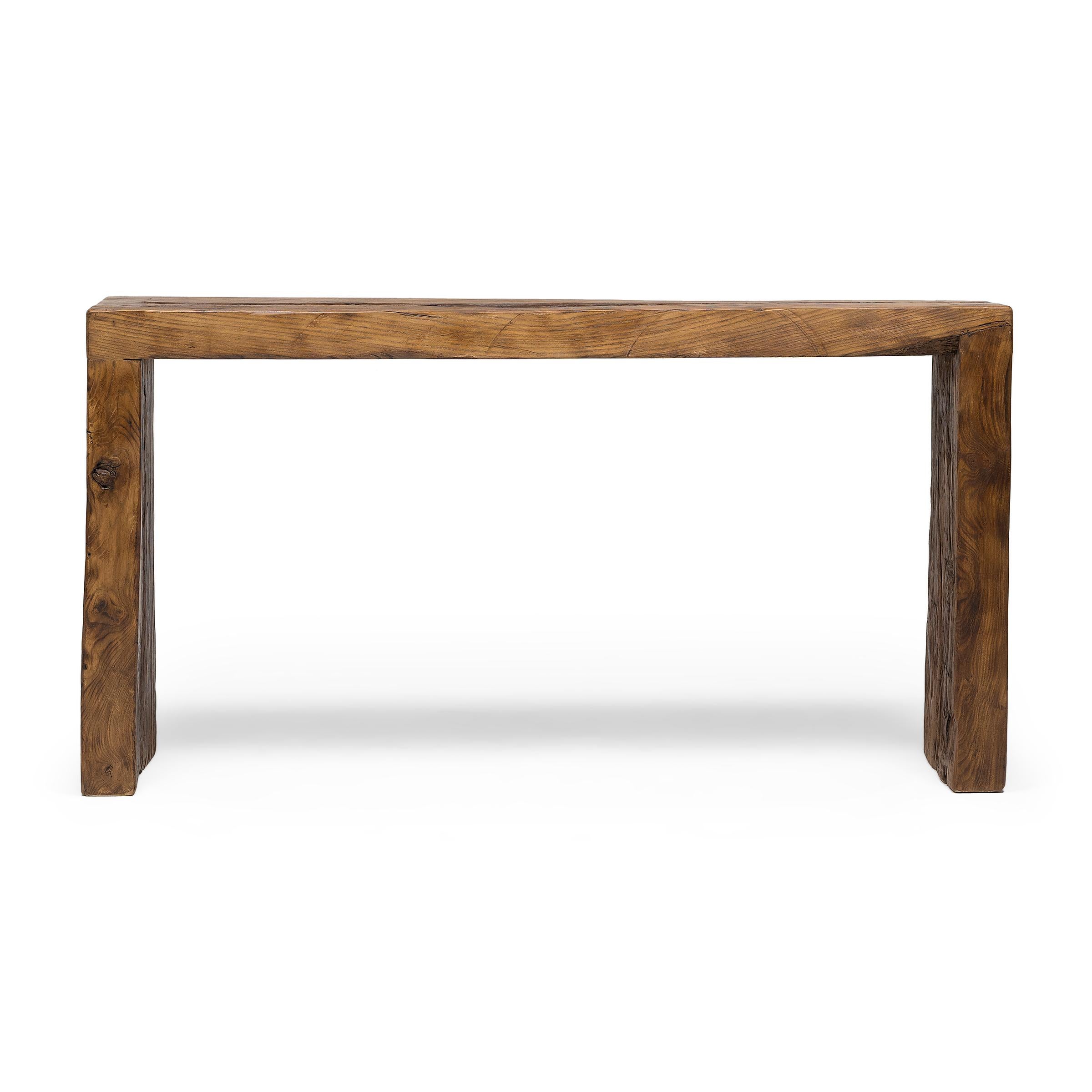 This contemporary console table is a celebration of wabi-sabi style. Crafted of wood reclaimed from Qing-dynasty architecture, the table has a minimalist waterfall design with dovetailed corners that recreate traditional joinery methods and add