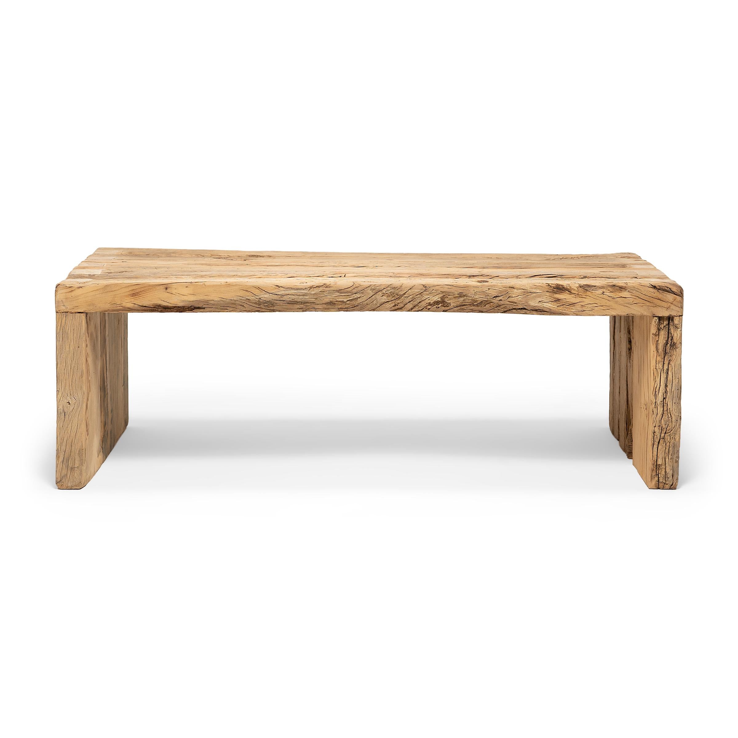 This artisan-crafted coffee table is a celebration of wabi-sabi style. Crafted of thick elmwood timbers reclaimed from Qing-dynasty architecture, the table has a minimalist waterfall design and is left unfinished to preserve the natural beauty of