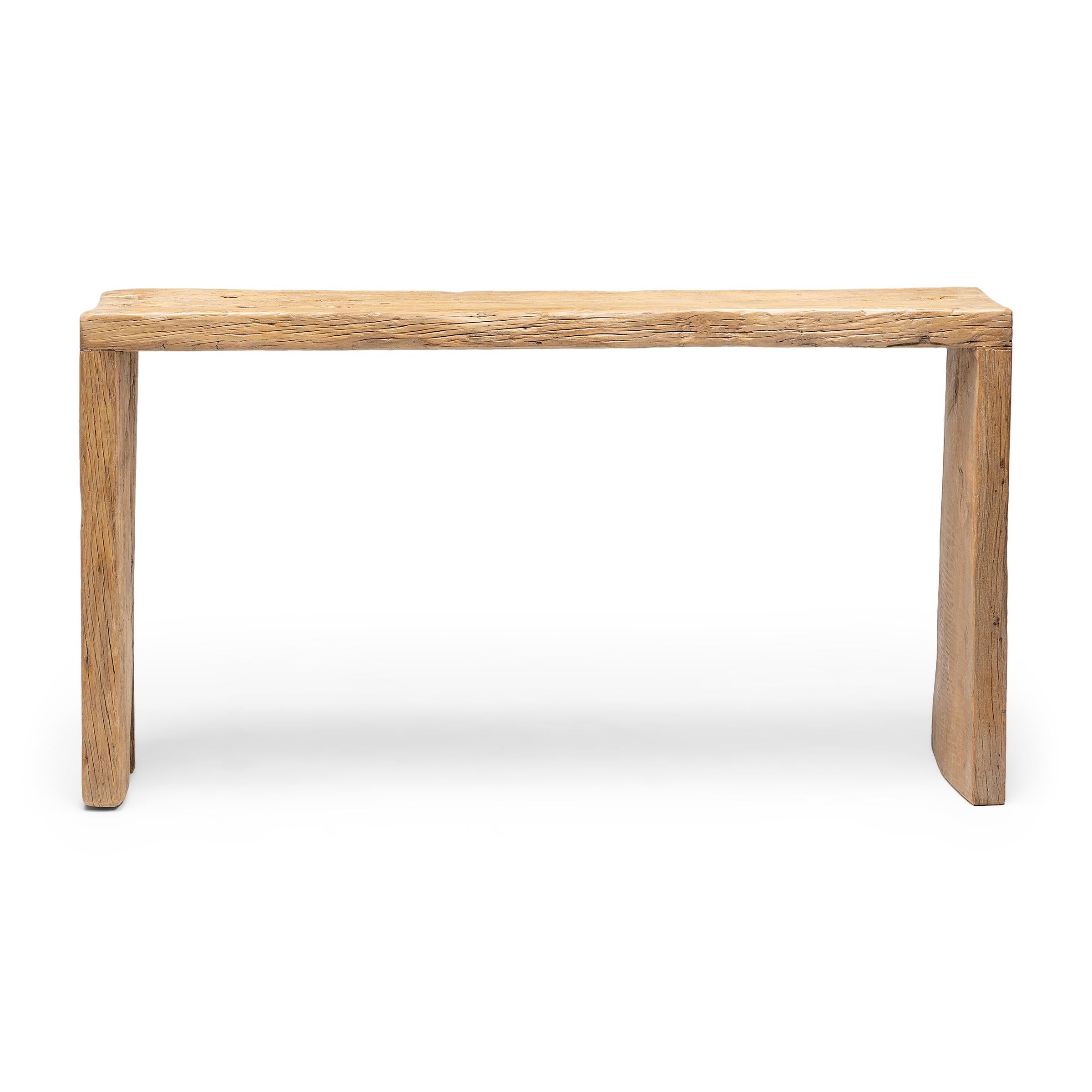 This reclaimed wood console table is a celebration of wabi-sabi style. Crafted of elmwood timbers salvaged from Qing-dynasty architecture, the table has a minimalist waterfall design with dovetailed corners that recreate traditional joinery methods.