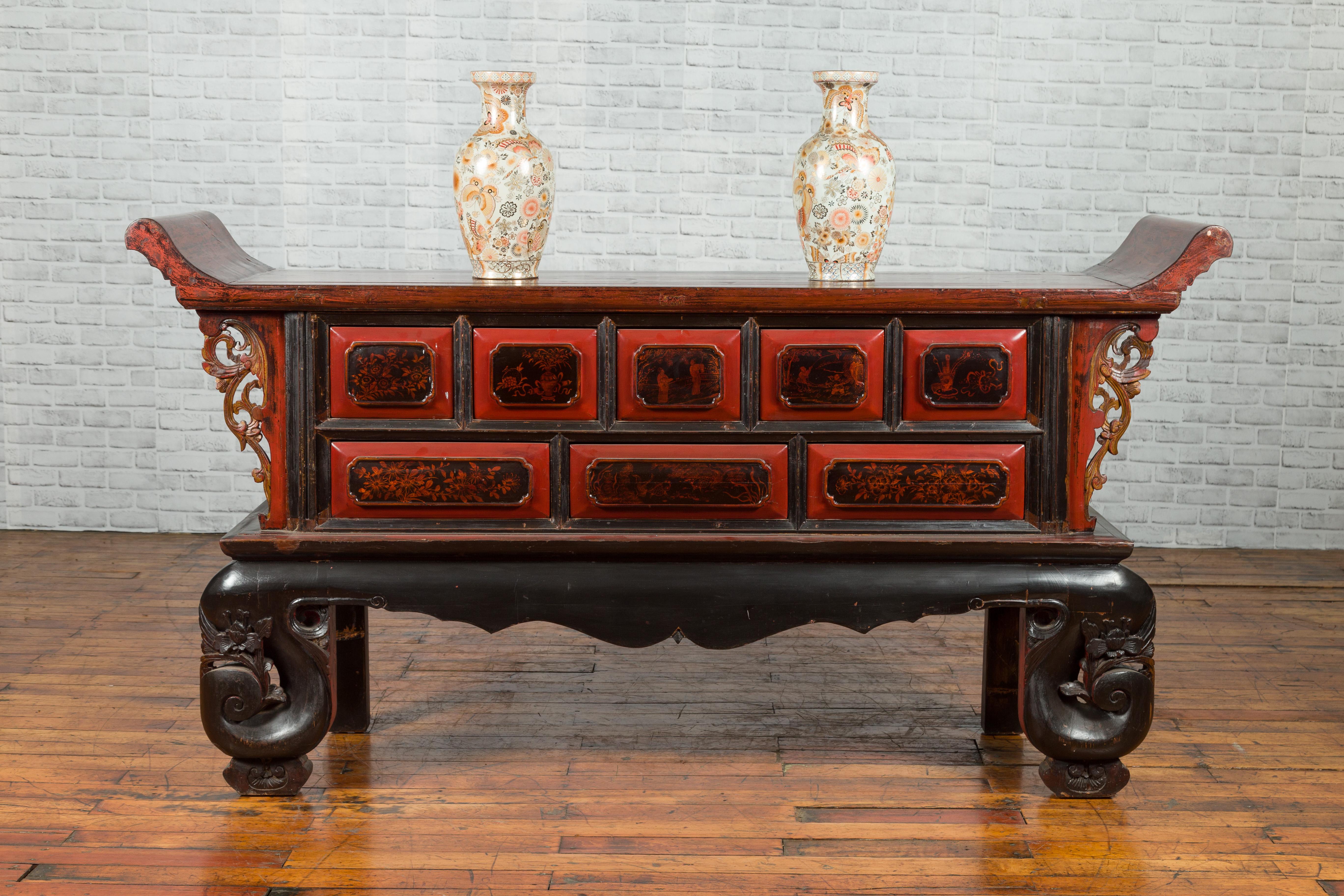 A Chinese red and black lacquered altar coffer table from the 19th century, with figural and floral motifs, everted flanges and carved legs. Created in China during the Qing Dynasty period in the 19th century, this altar coffer table, probably used
